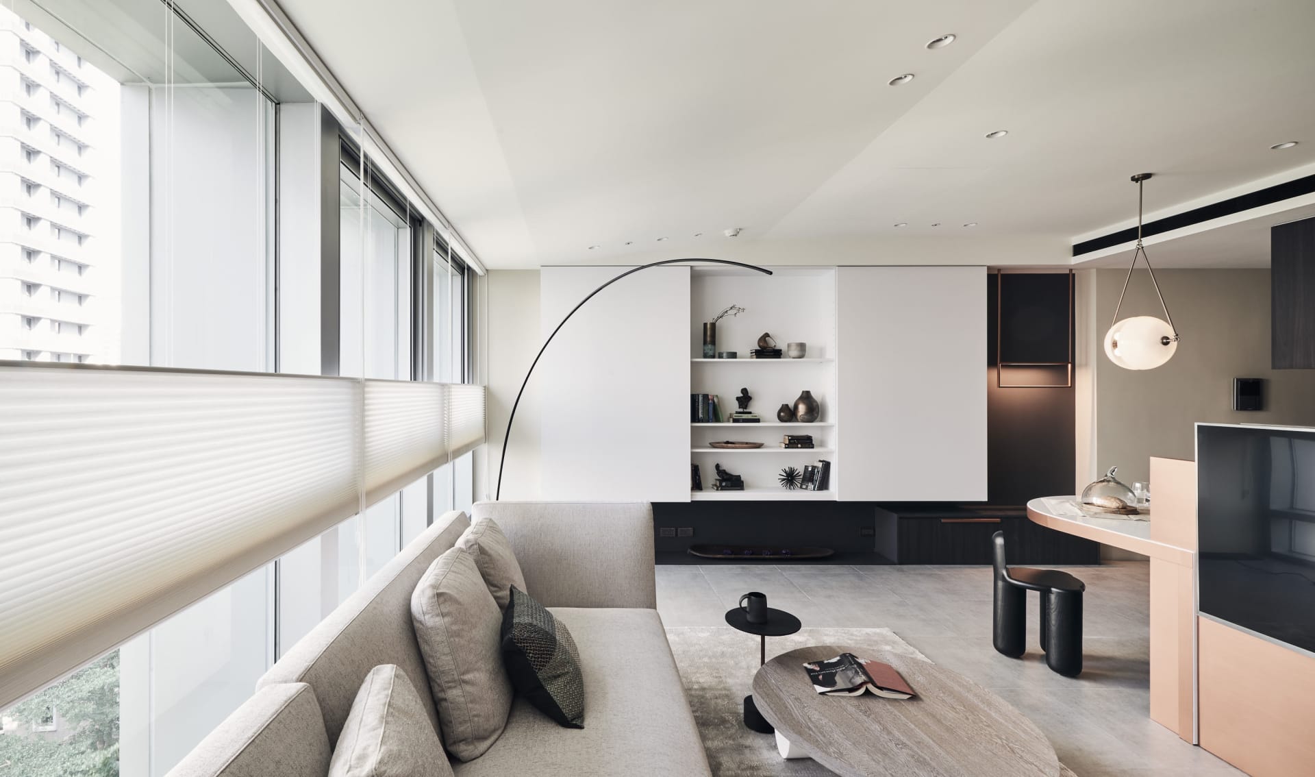 A modern minimalist living room featuring paneled walls and a large floor lamp.