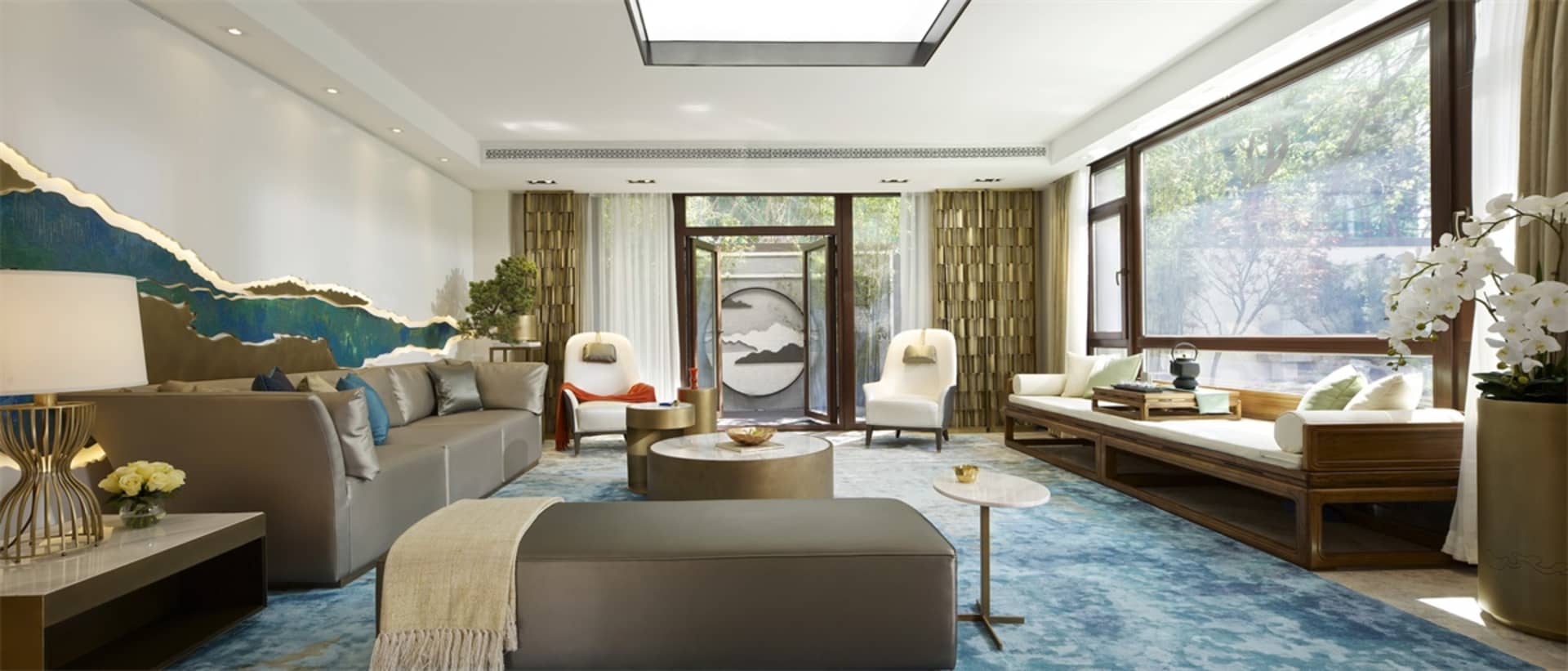 Modern living room with a blend of contemporary and natural elements, featuring plush sofas, a stylish coffee table, and larg