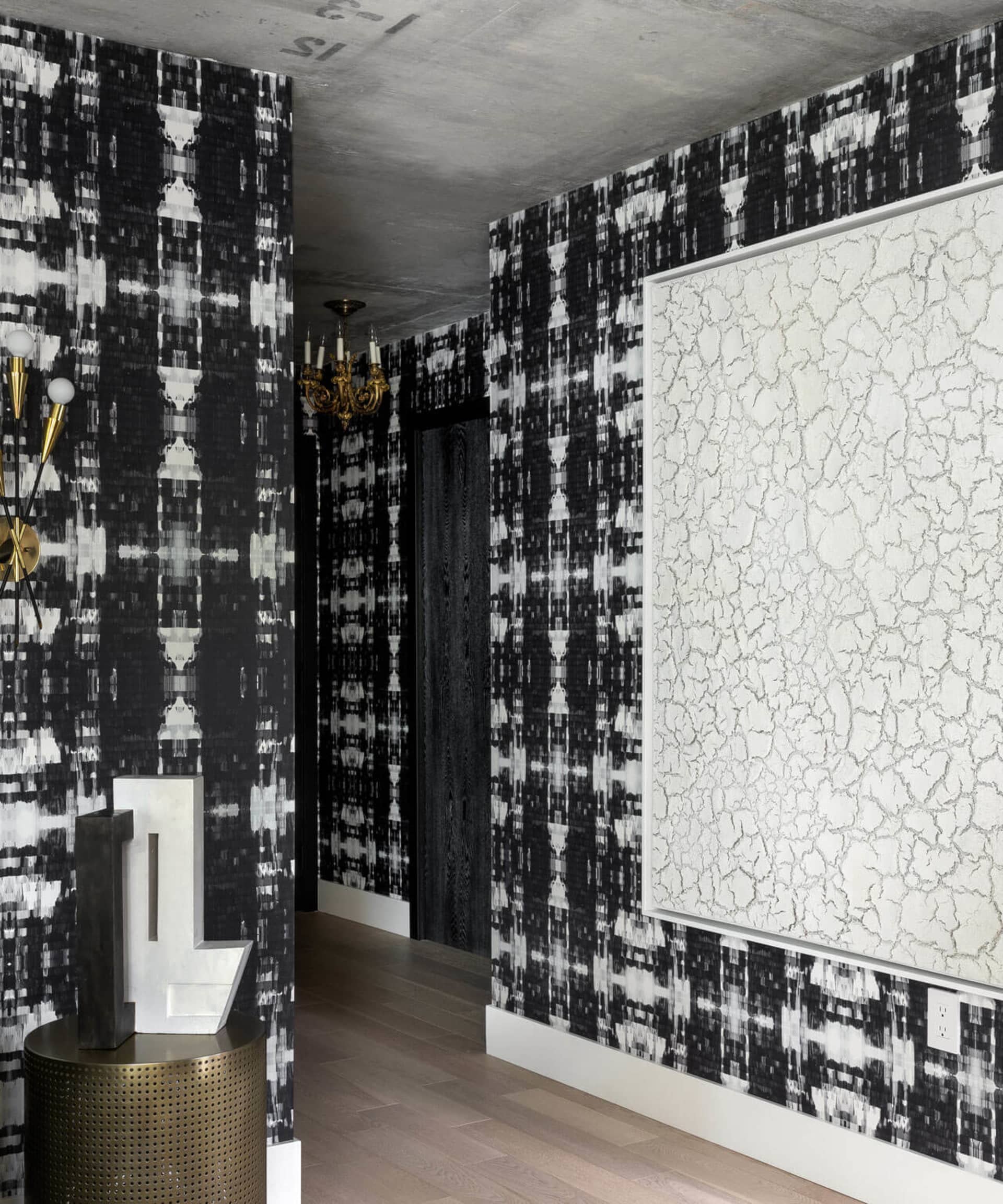 Modern, luxurious hallway featuring patterned wallpapers and a concrete finish.