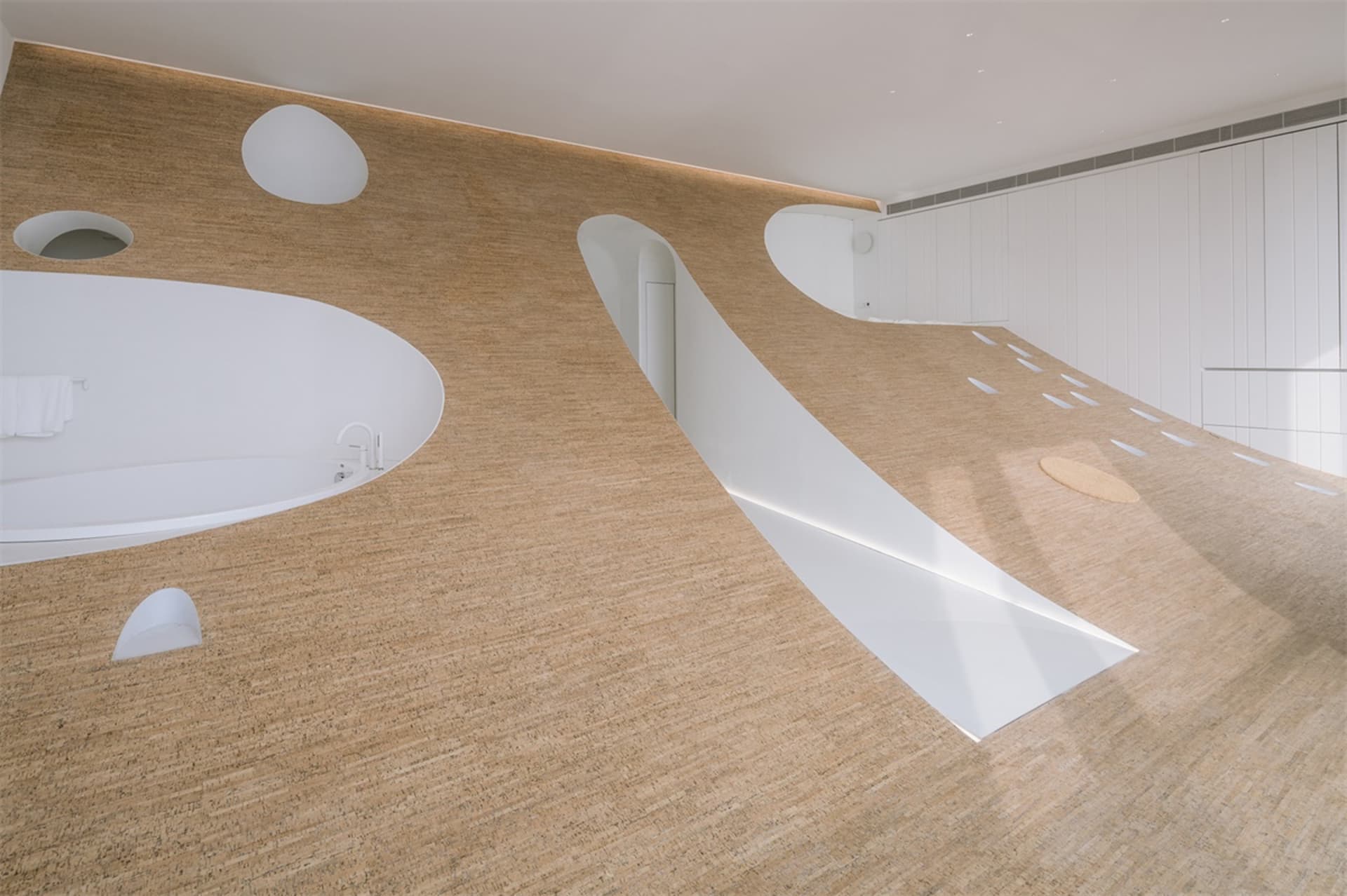 Modern bathroom with a wooden texture wall and floor, featuring a bathtub and an oval-shaped space.