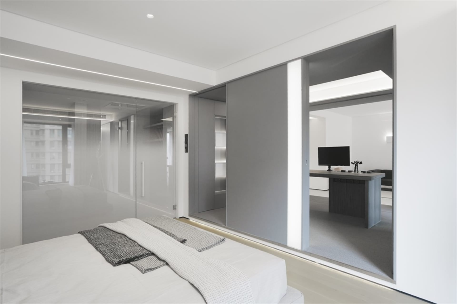 Modern bedroom featuring glass, wood, and leather furniture, showcasing contemporary design elements and sleek finishes.