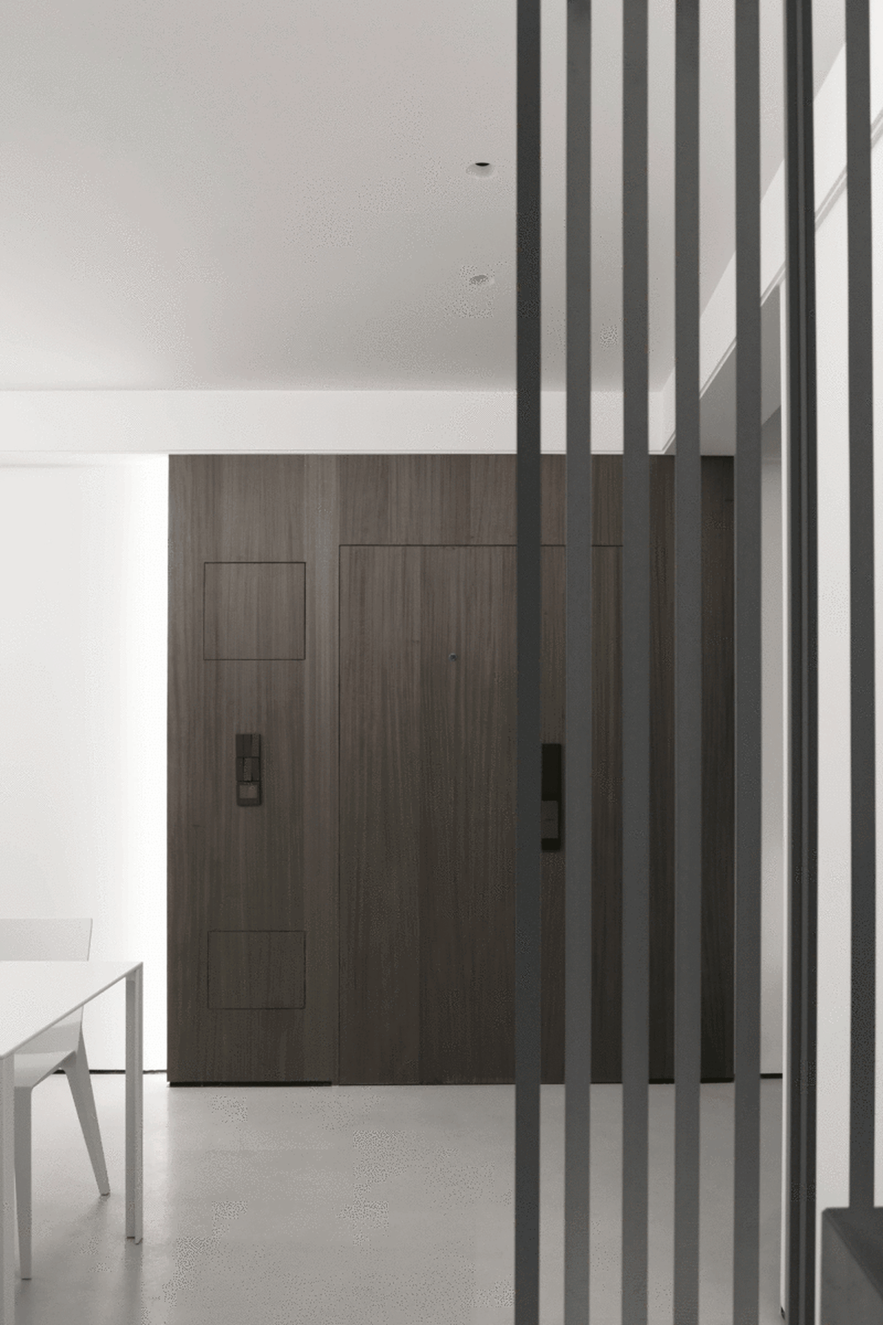 Modern entrance hall with wooden doors and white flooring