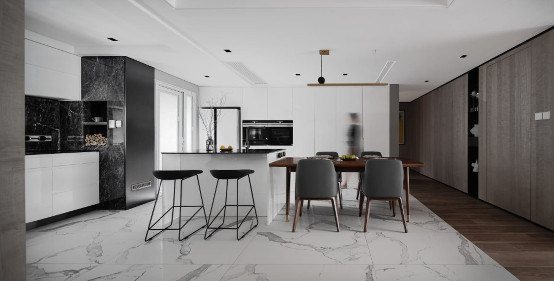 Modern residential kitchen with marble countertops and white walls