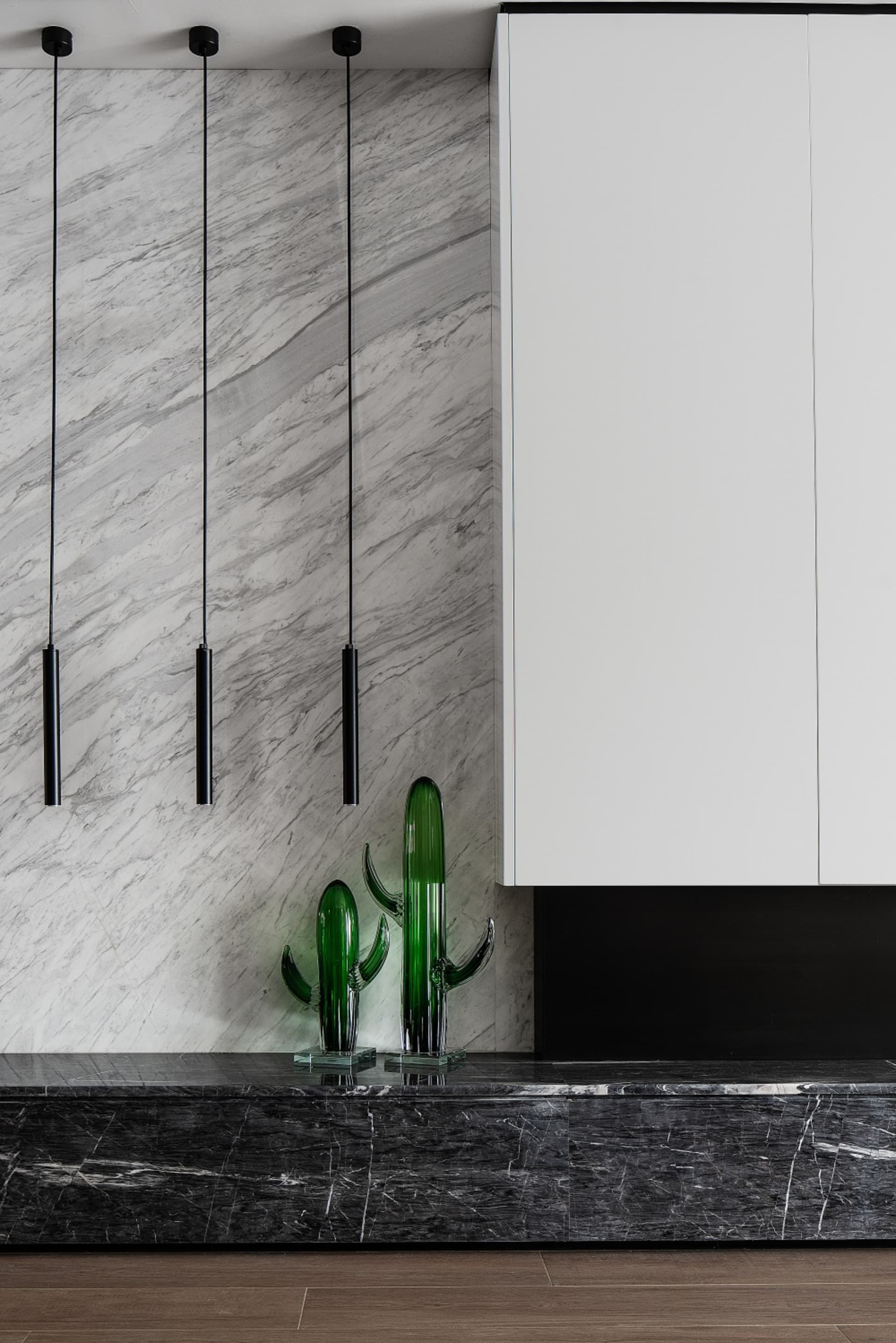 A modern interior design featuring marble surfaces and minimalist decor.