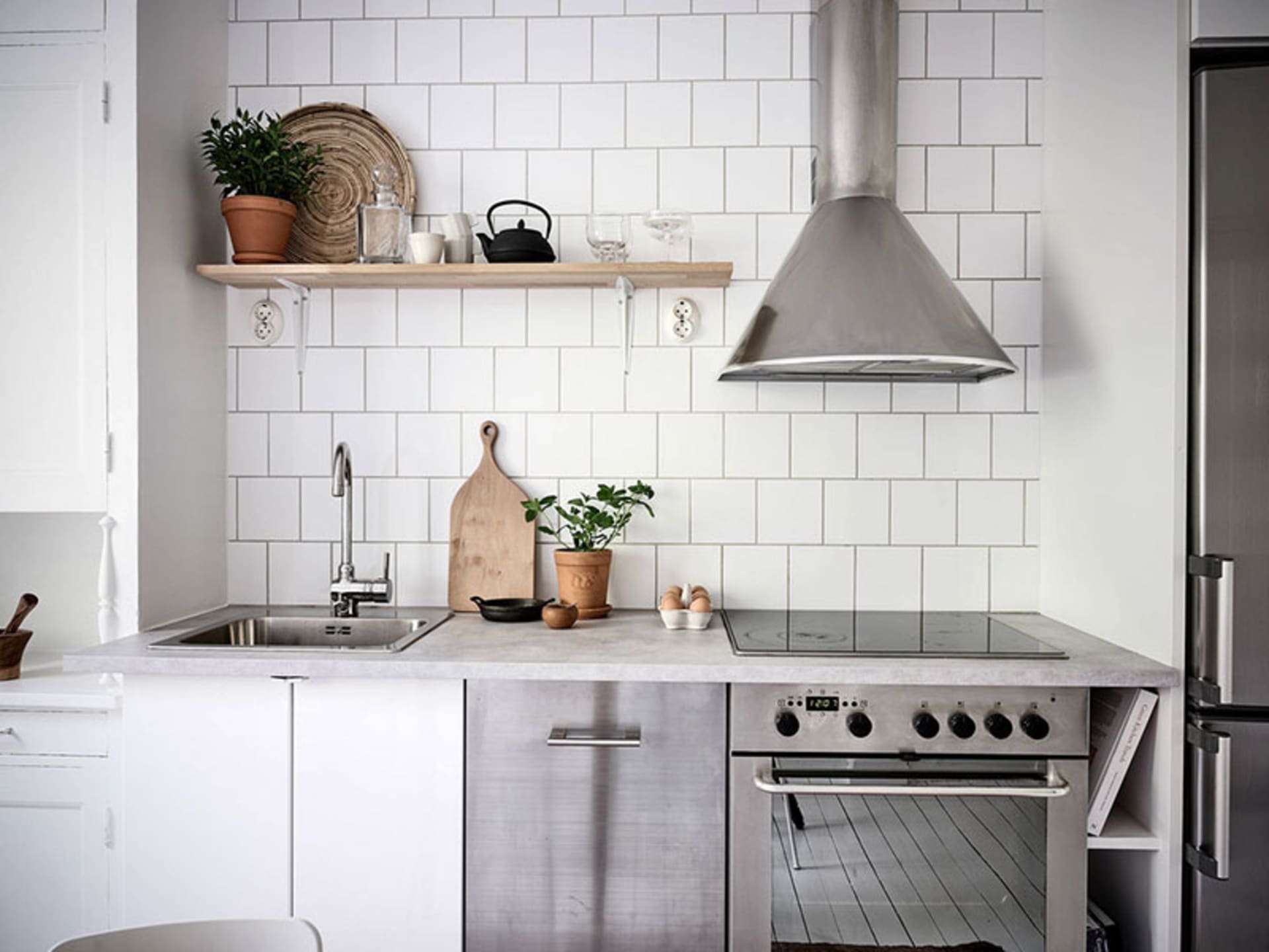 Modern minimalist kitchen featuring white subway tile backsplash.