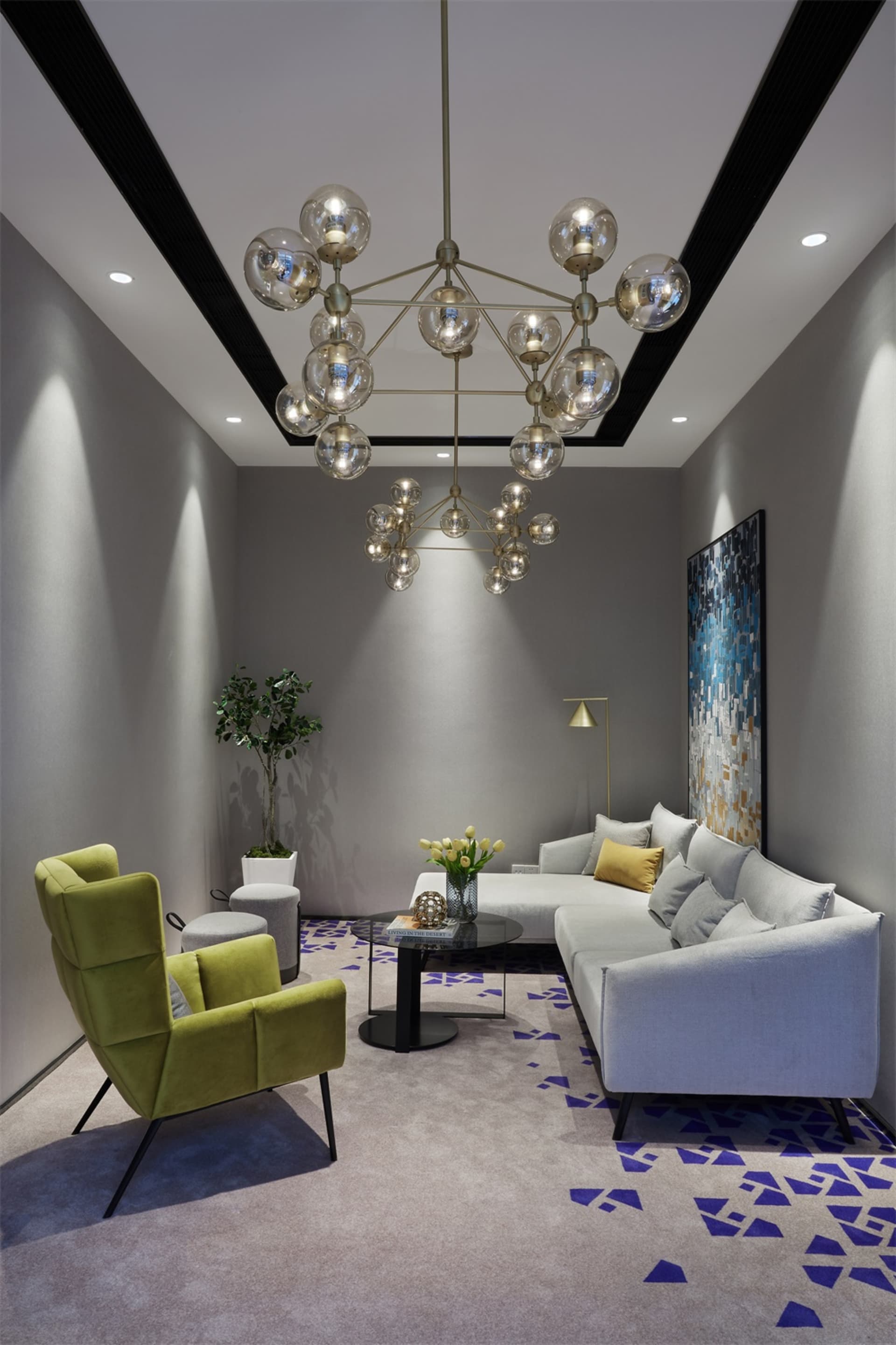 A modern living room featuring velvet furniture, concrete floor, and patterned rug