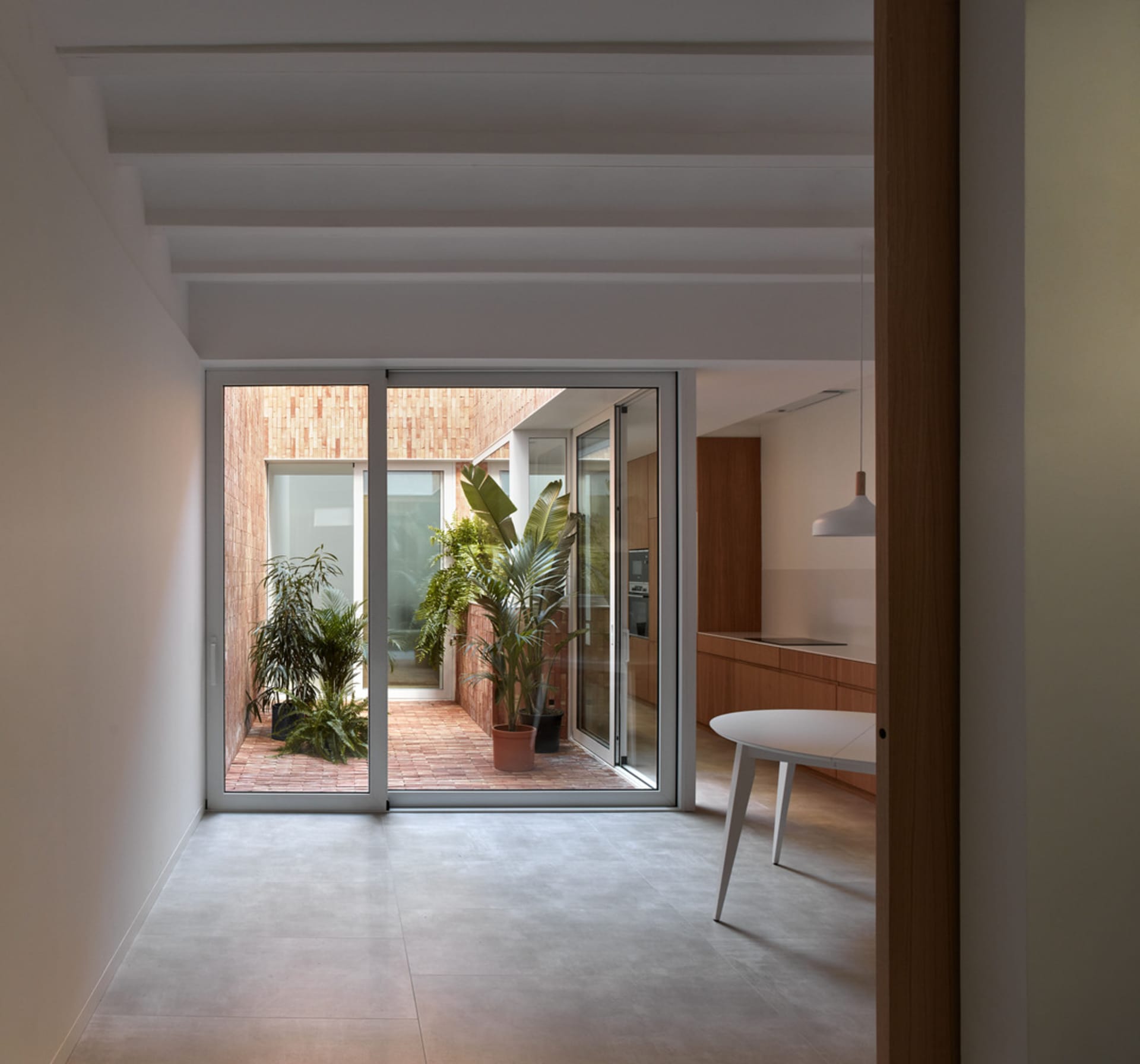 A modern kitchen extension with concrete and brick materials.