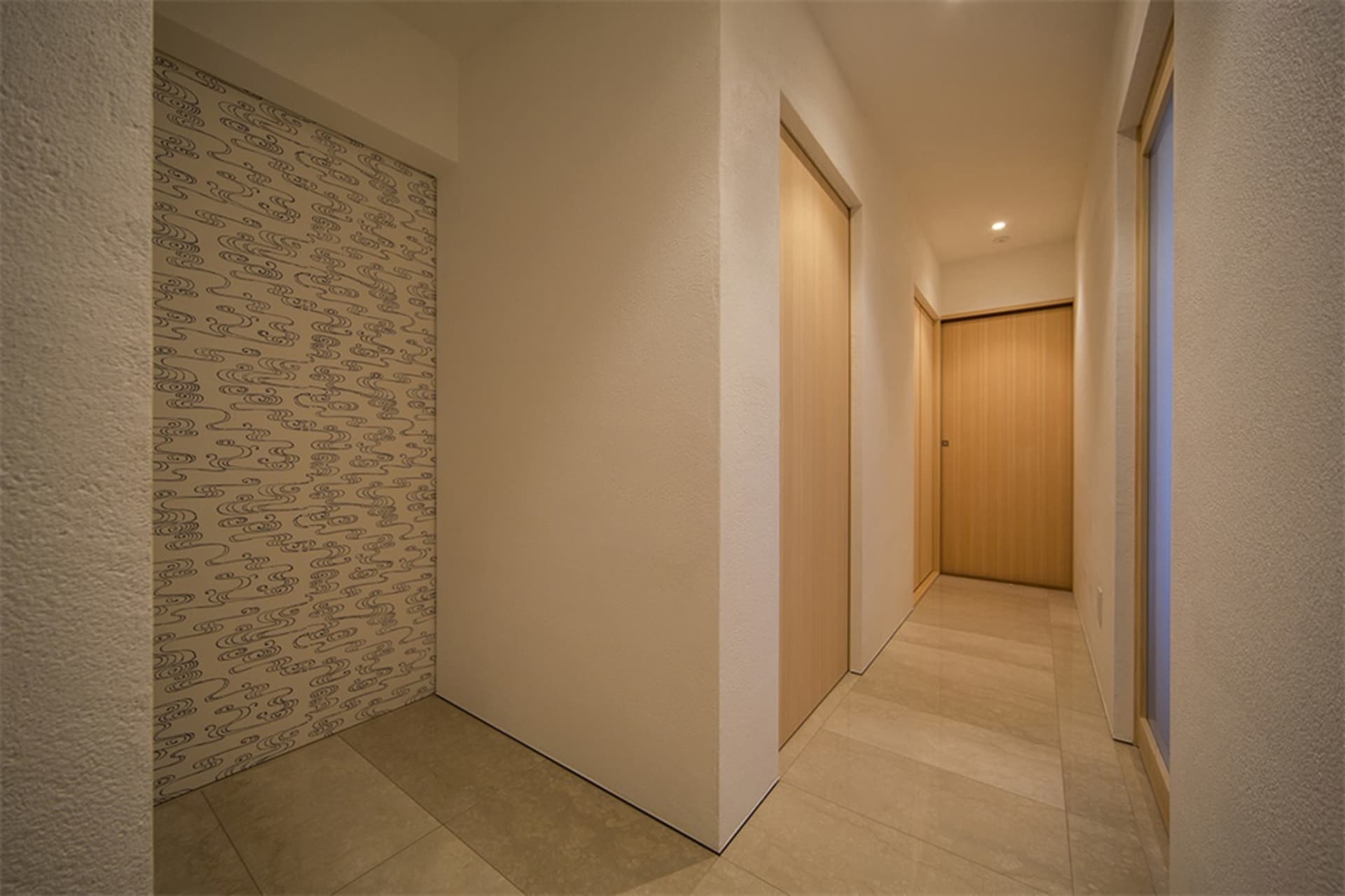 A minimalist house hallway with wooden walls and doors.