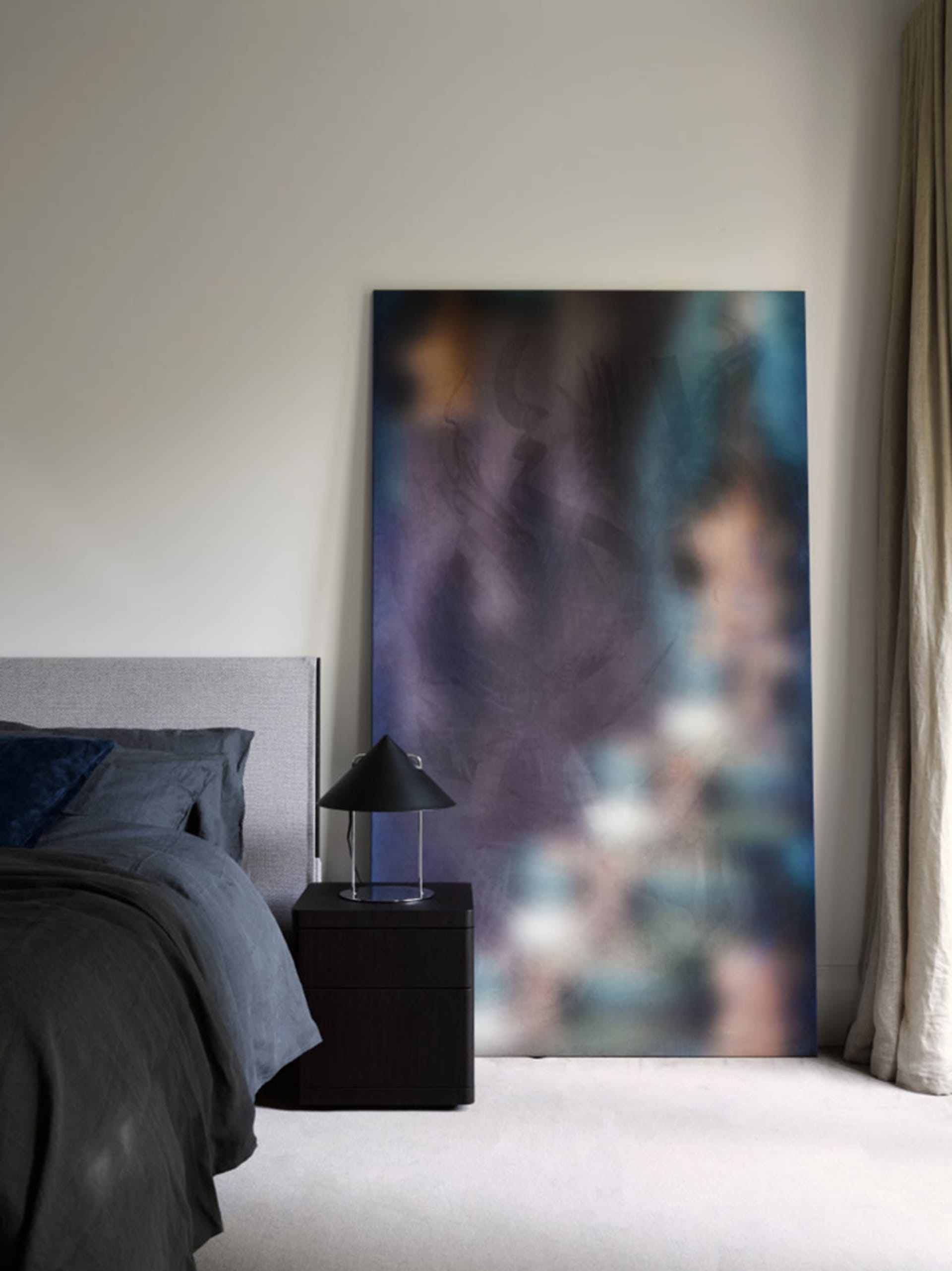 Modern bedroom featuring abstract fabric texture art, minimalist design, and contemporary interior elements.