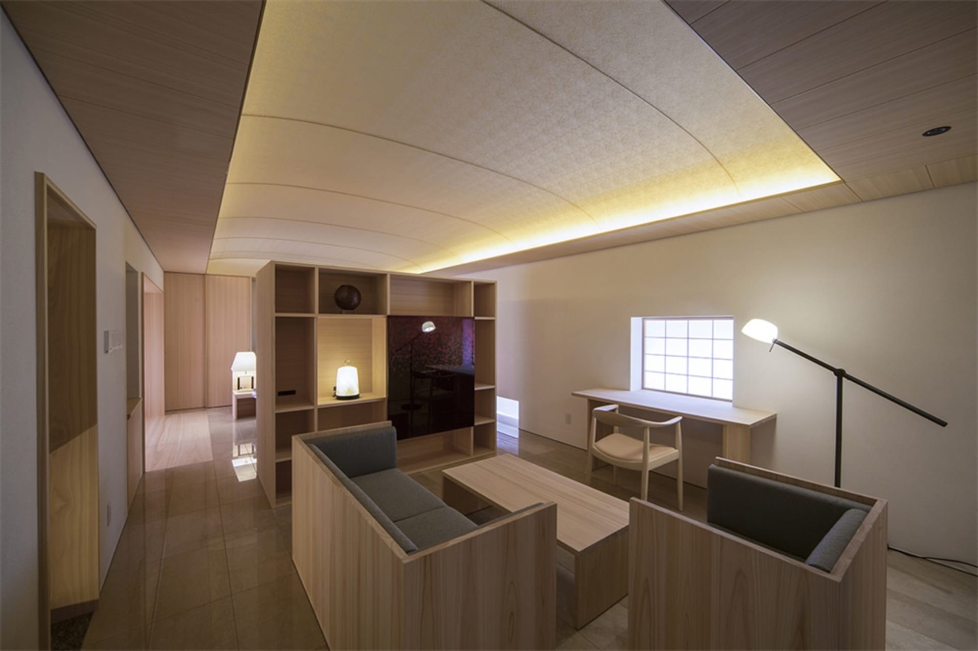 Modern living room featuring minimalist design with wooden furniture and lighting elements.