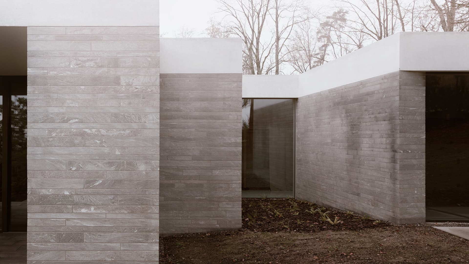 Modern building exterior featuring a contemporary design with concrete walls and clean lines.