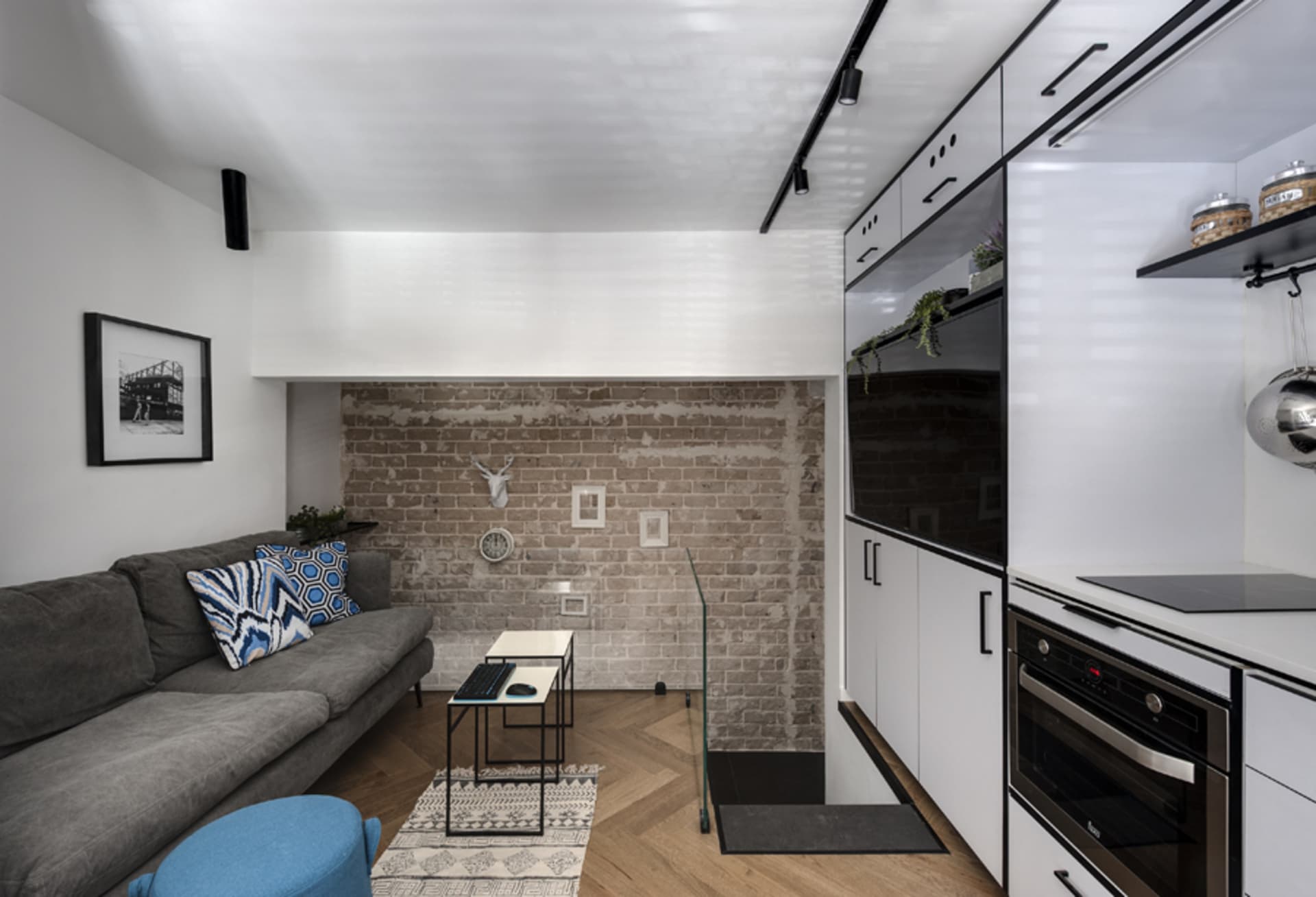 Contemporary living room with exposed brick wall and minimalistic furniture.