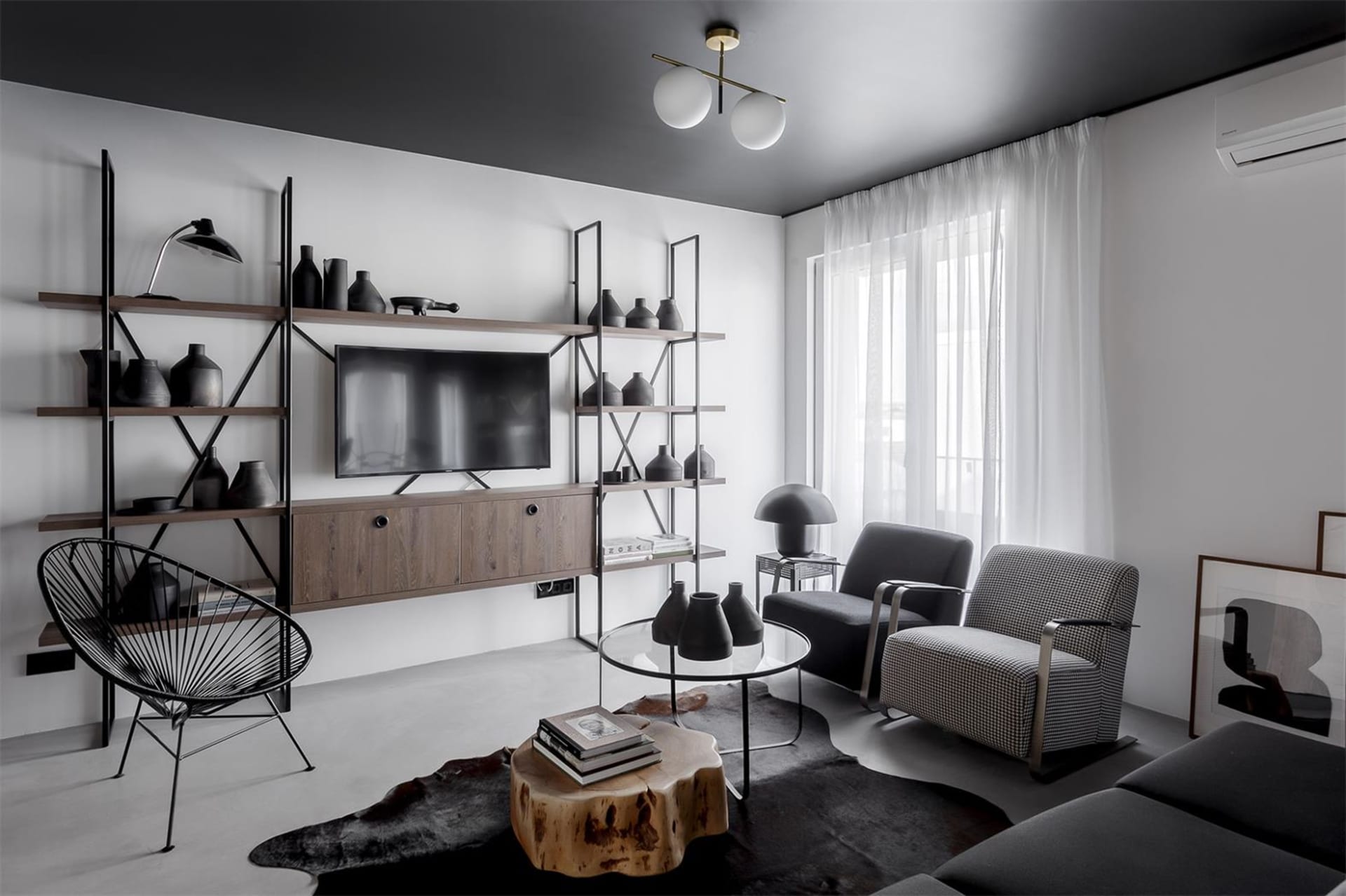 A modern living room with metal and wood furniture and decor.