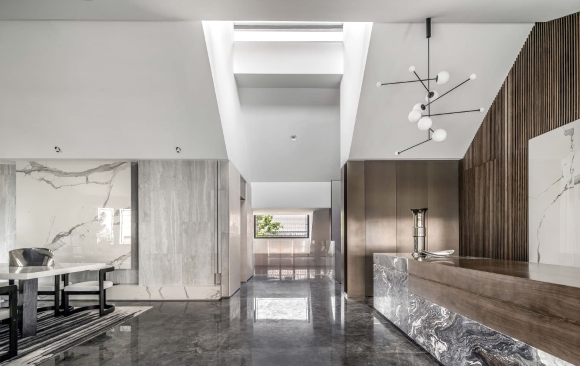 Modern lobby interior with marble, concrete, and wooden elements