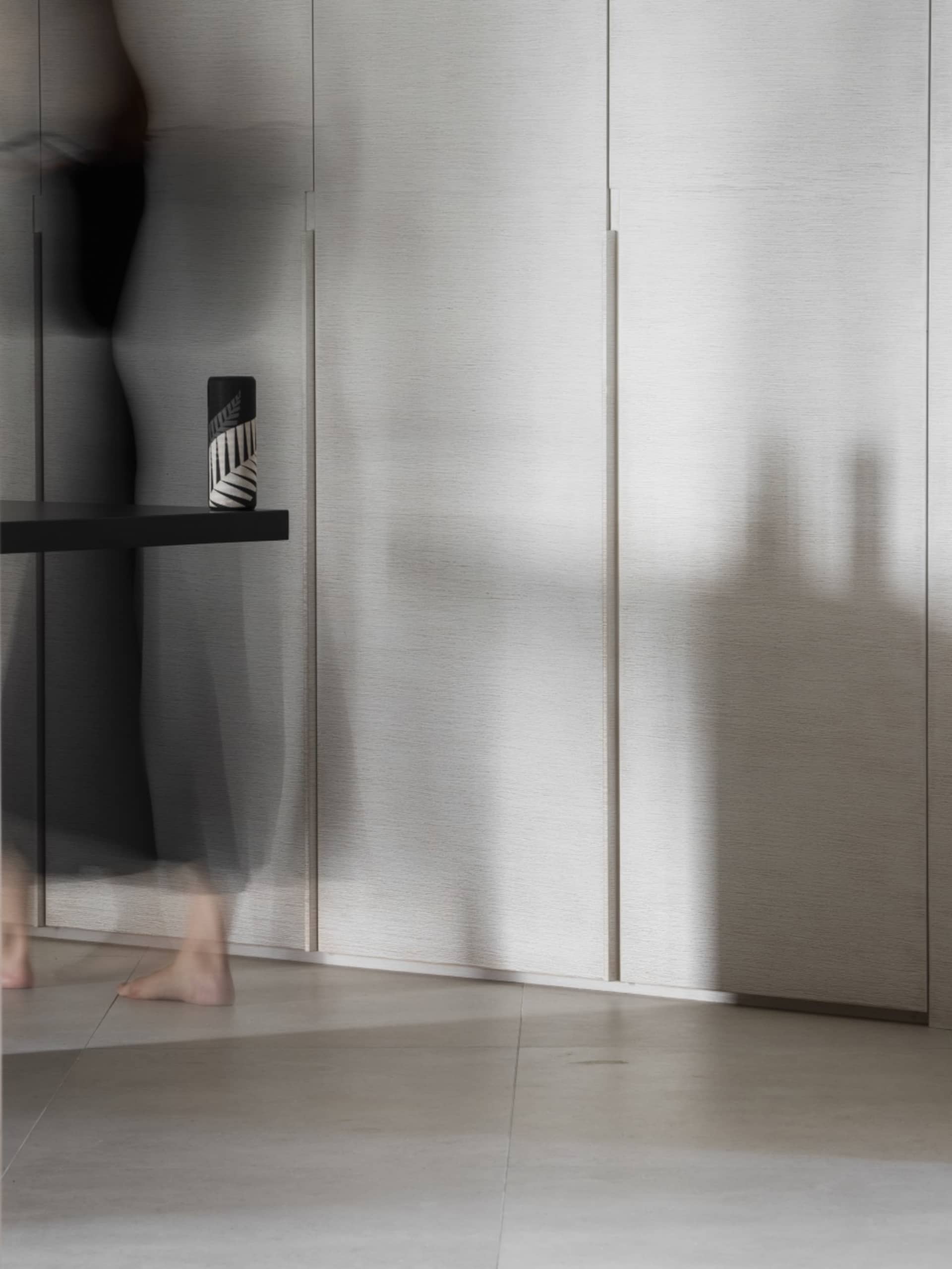 A minimalist interior with monochromatic color scheme and modern materials.