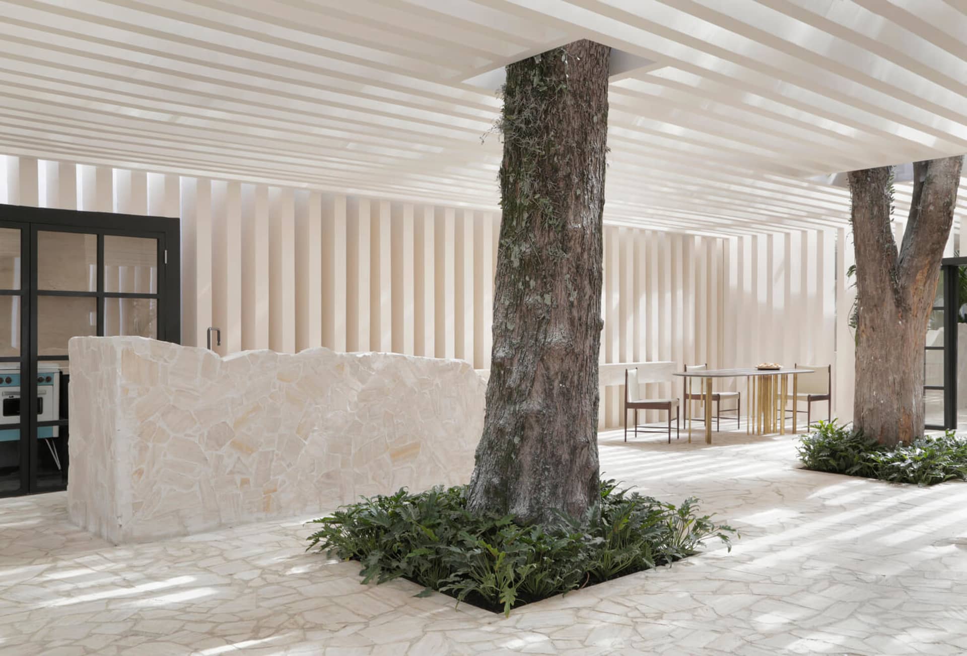 Modern minimalistic living room with concrete floor and natural stone accents