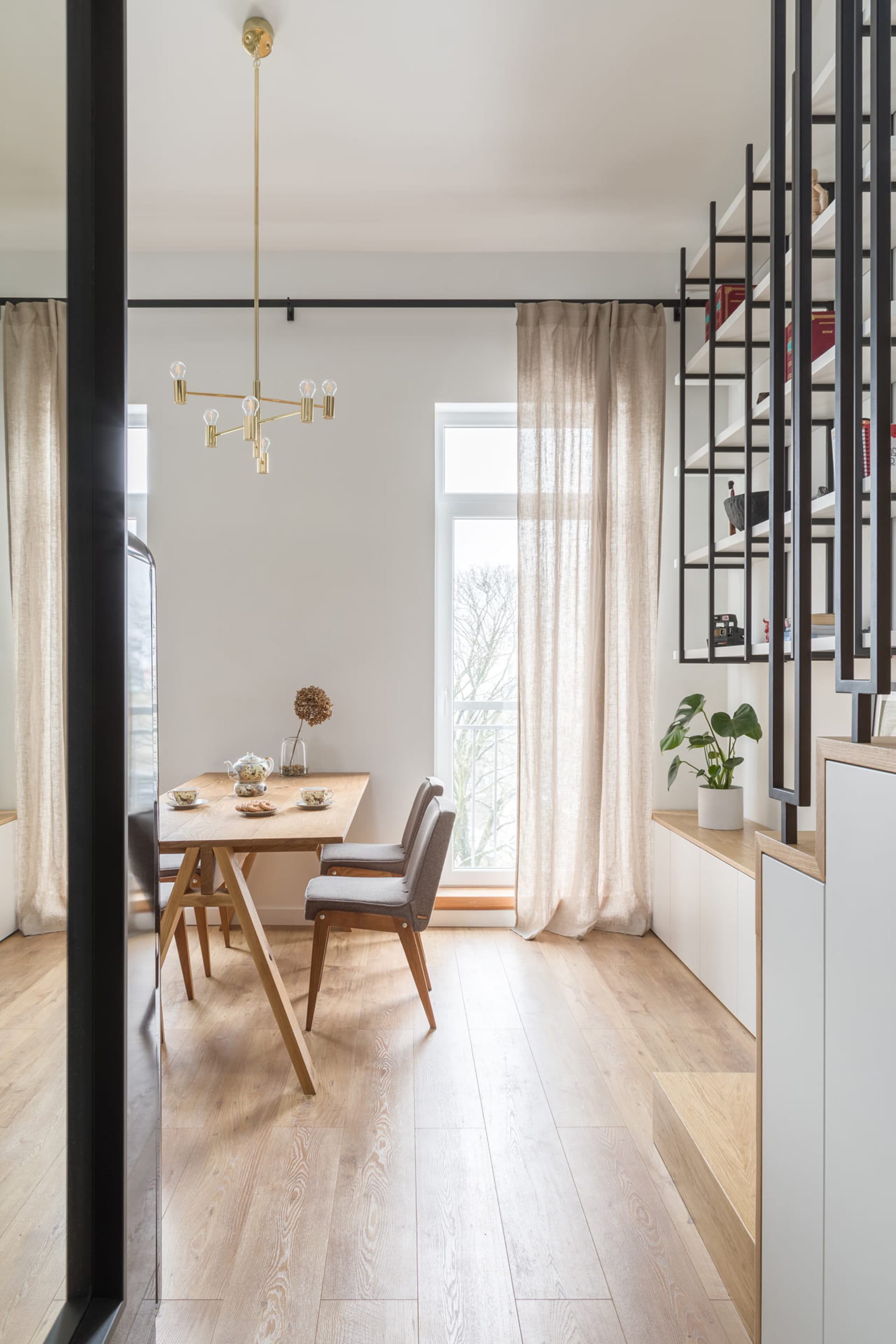 A minimalist residential interior featuring wooden furniture with a modern, clean design.