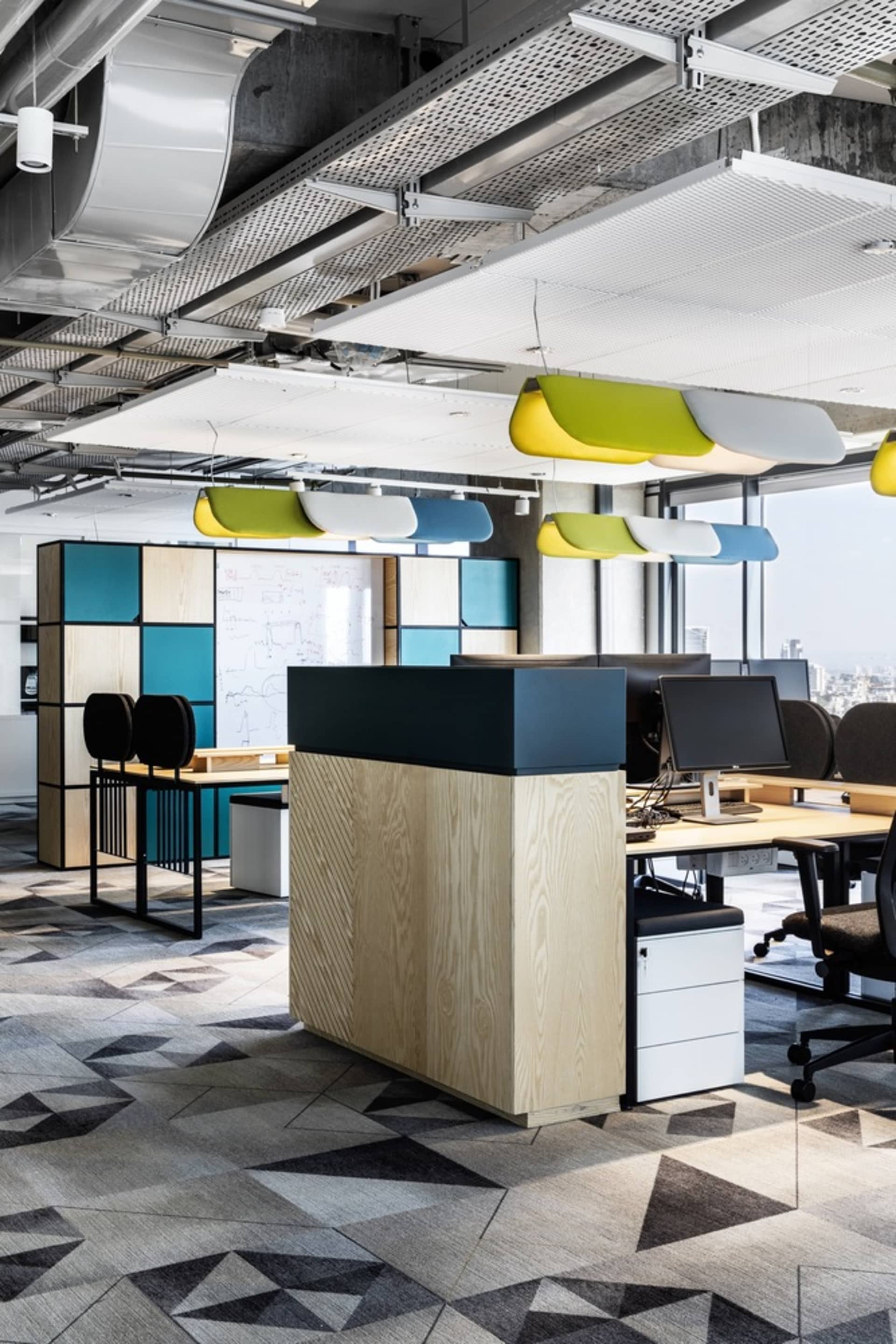 A modern office space with wooden furniture and colorful lighting.