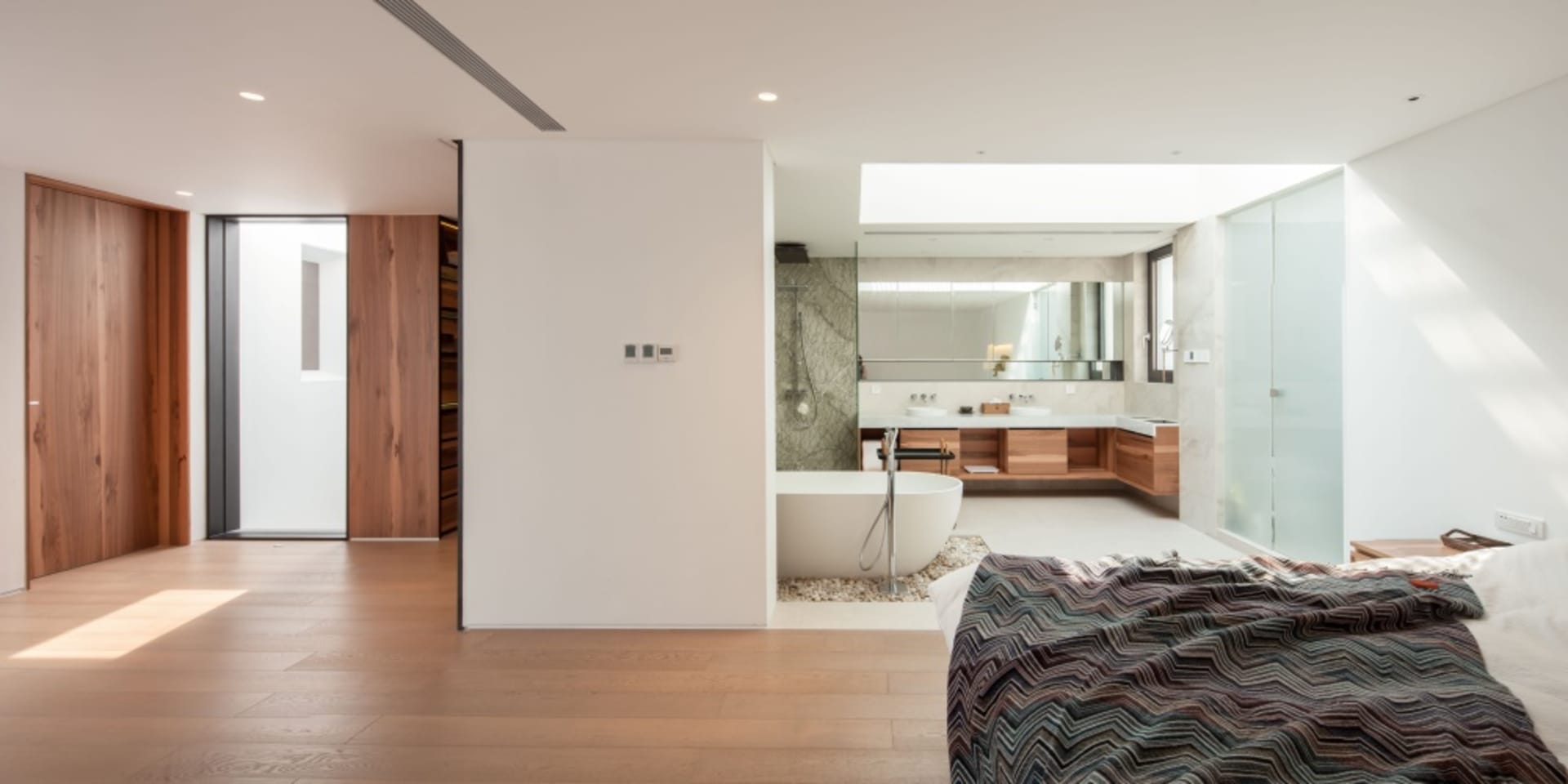 Modern residential interior with wooden floors and a minimalist bathroom design.