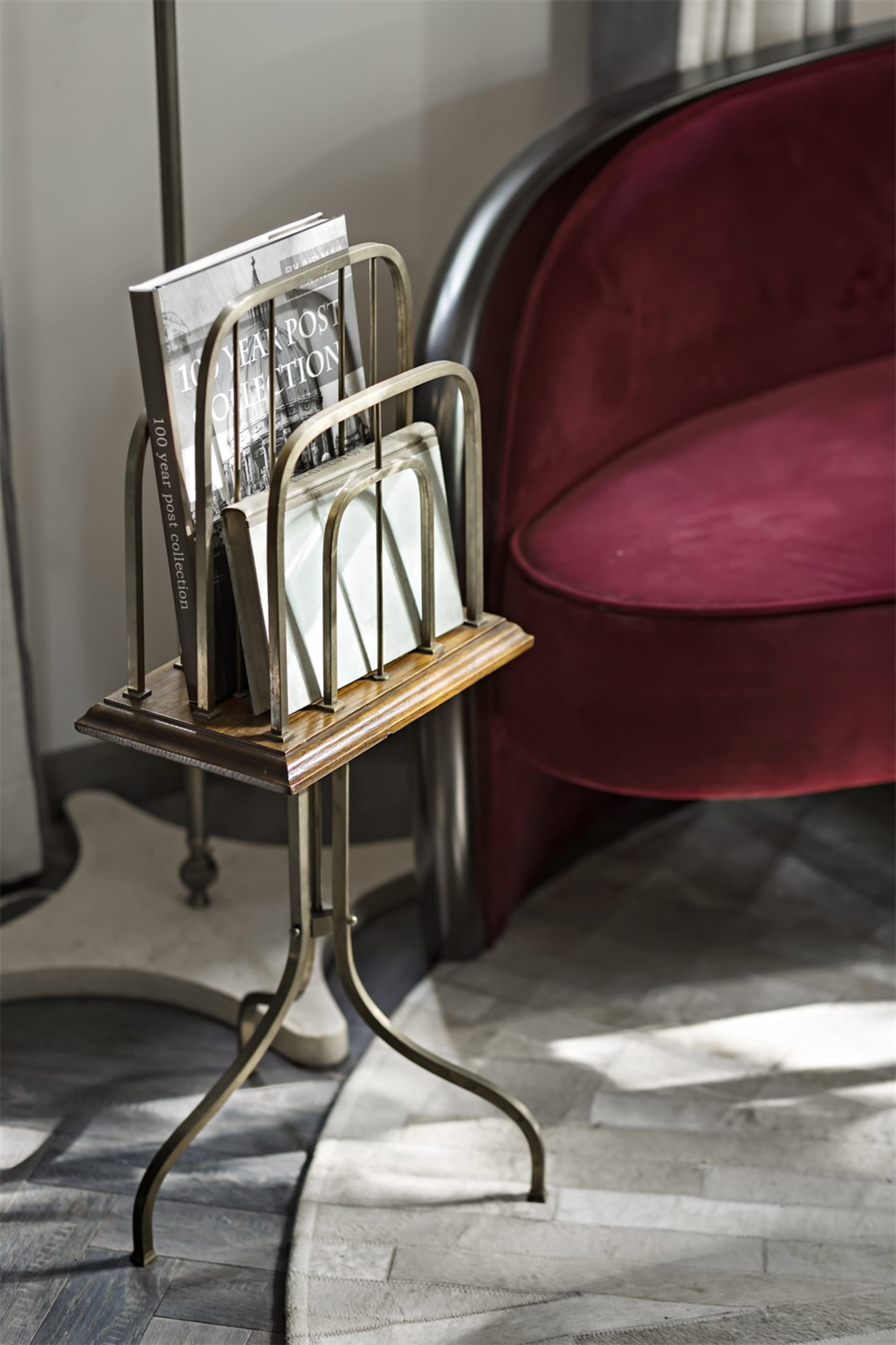 A metallic magazine stand featuring a sleek, modern design.
