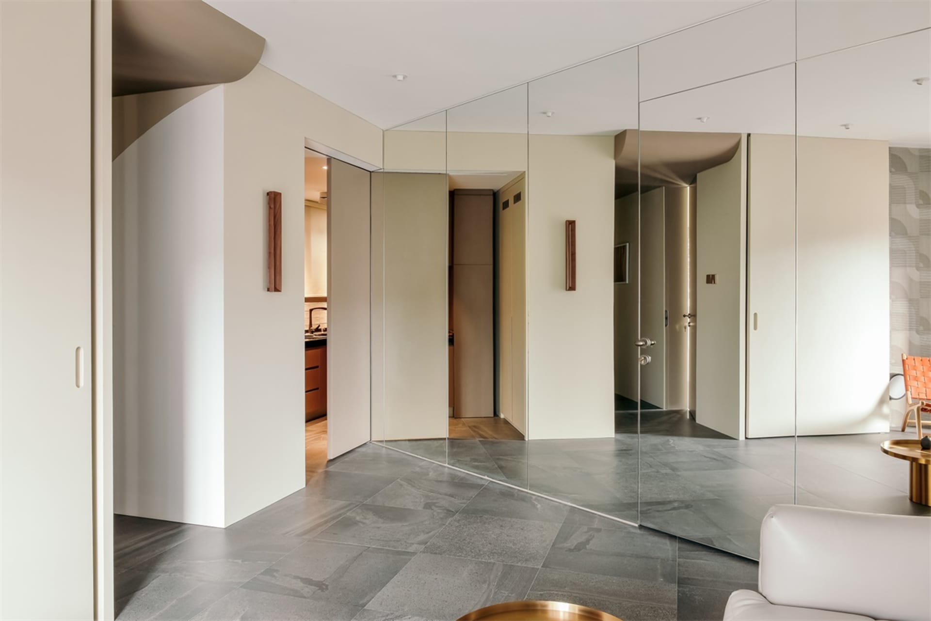 Modern living room featuring glass panel walls, minimalistic decor, and a sleek, contemporary design.