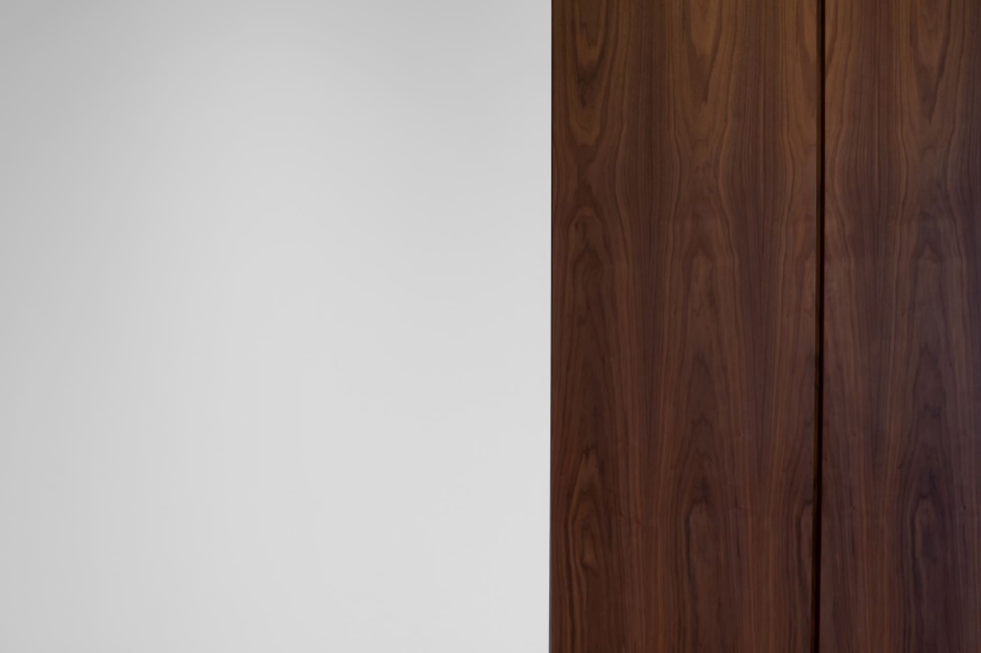 A close-up view of a wooden door with a minimalist design.