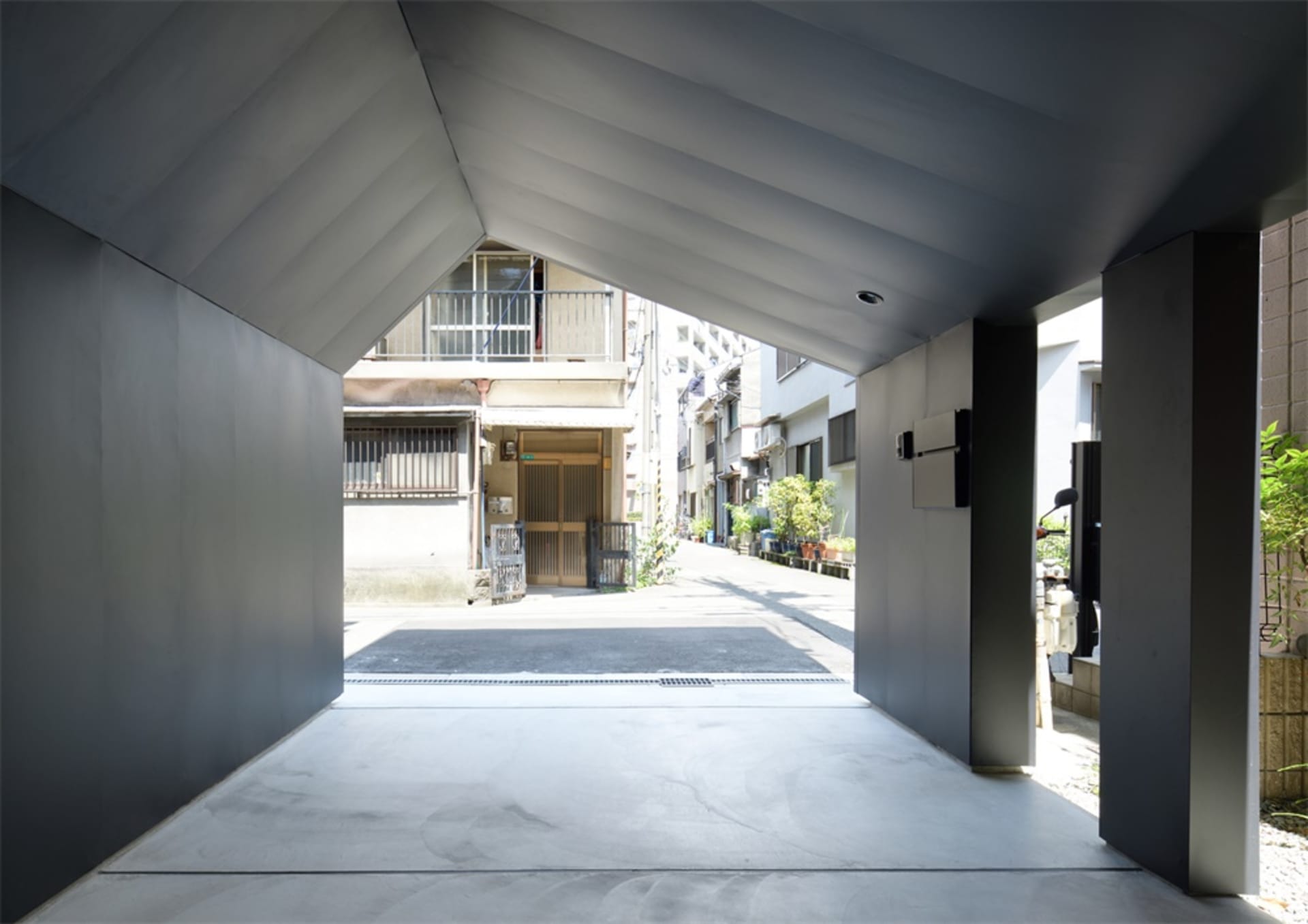 An urban entrance way featuring modern, minimalist architectural design elements.