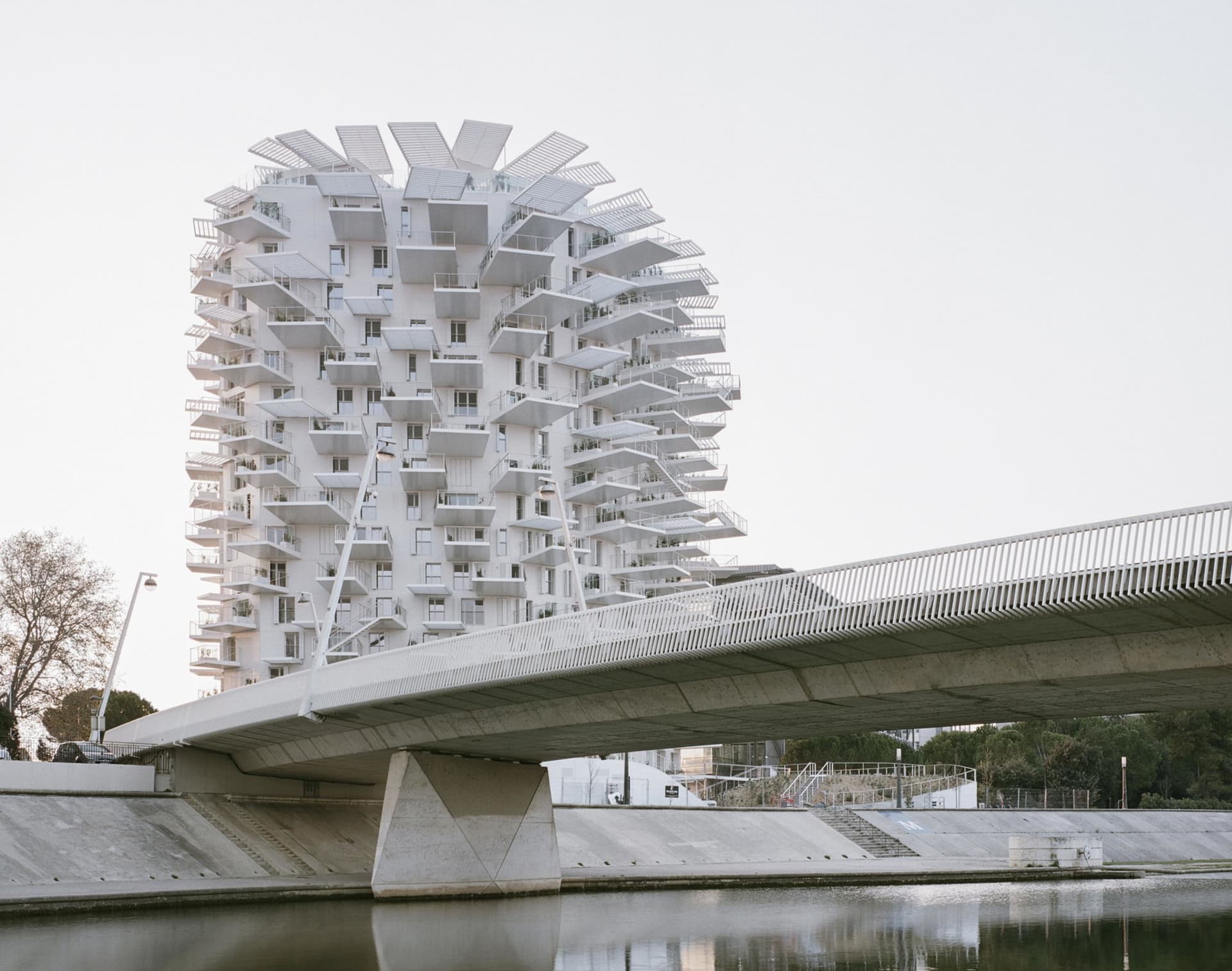 A modern residential building with a unique concrete exterior and multiple balconies.