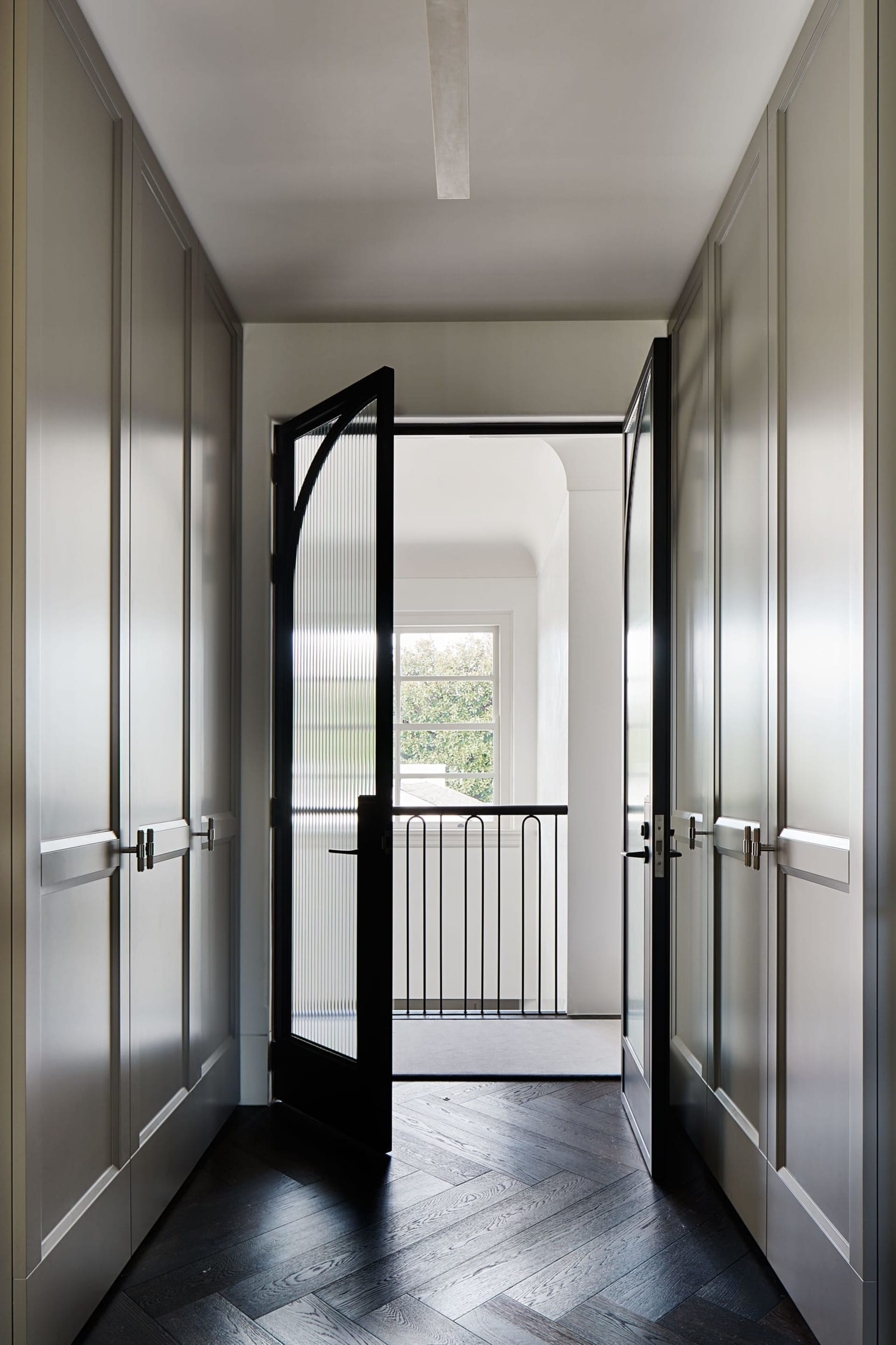 A modern interior with a black-framed glass door panel, showcasing clean lines and minimalist design features.