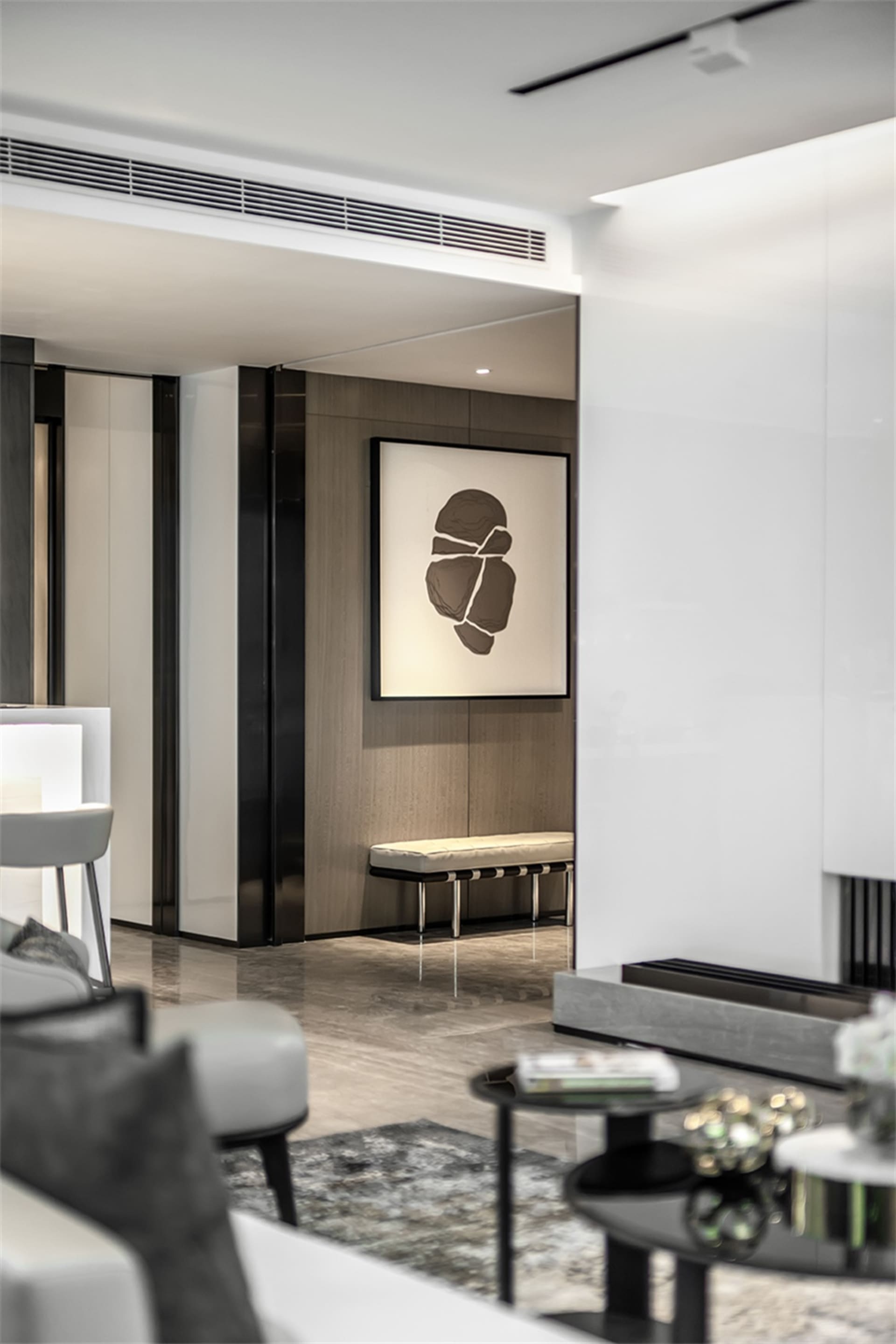 Modern interior design featuring marble surfaces, wooden panels, and metallic accents.