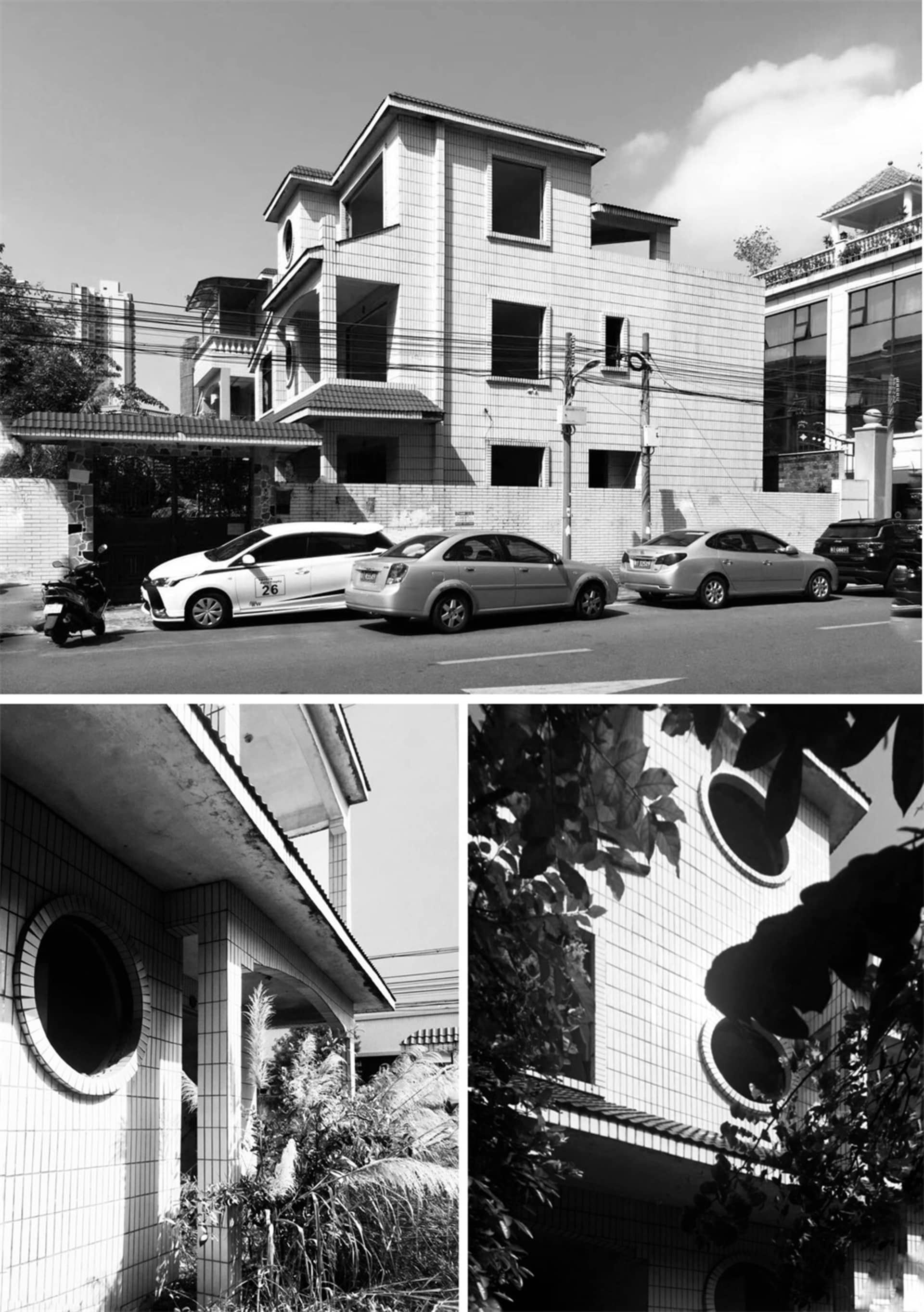 Three-story commercial office building with tiled exterior, multiple cars parked in front.