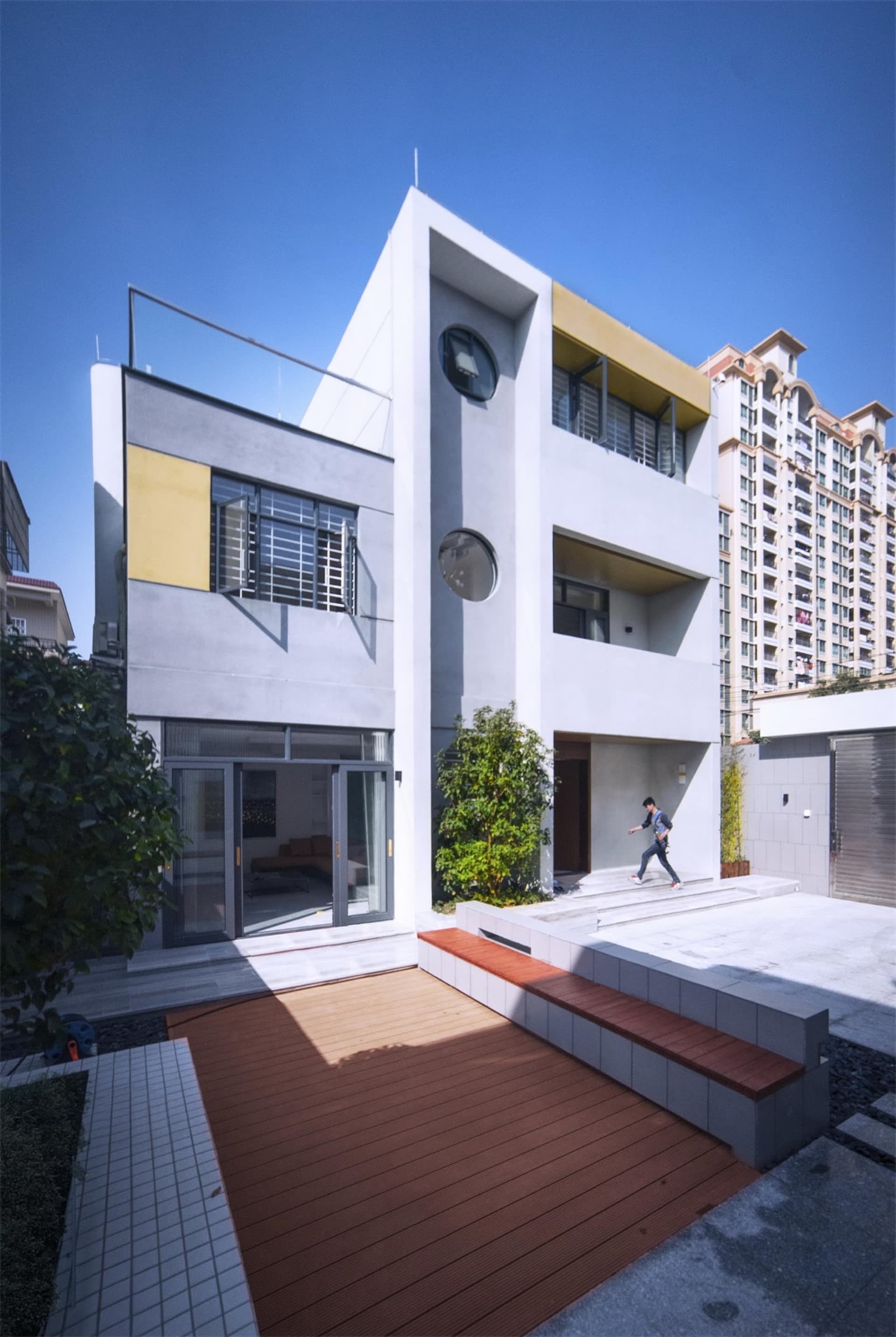 Modern residential exterior featuring concrete, glass, and metal materials.