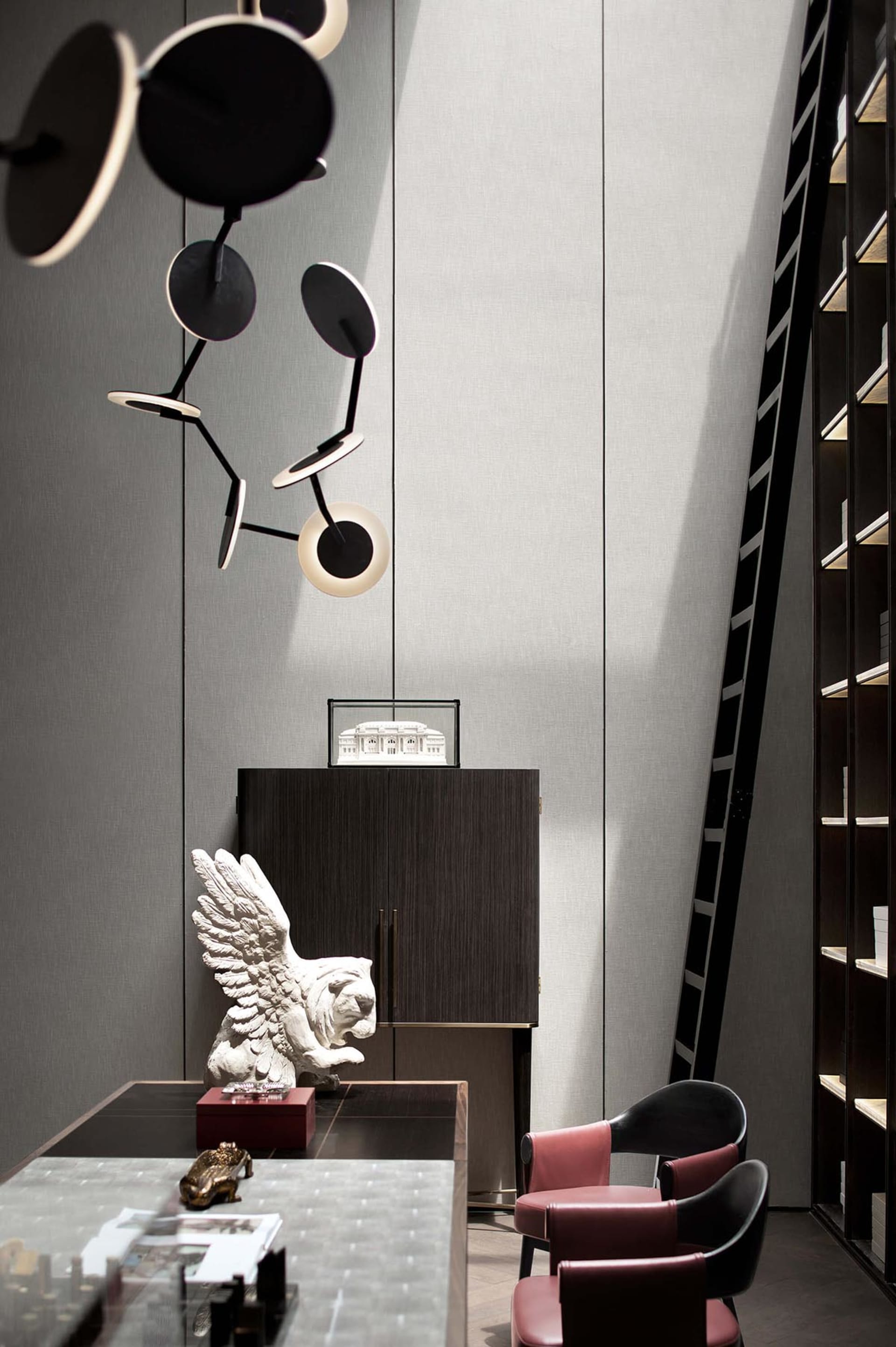 Modern office space with a combination of wooden furniture, glass elements, and leather chairs, featuring a contemporary ligh