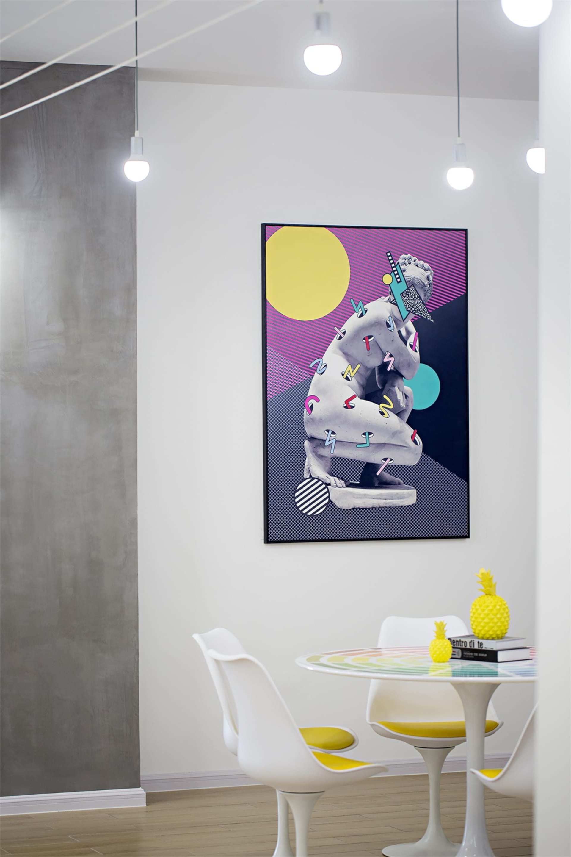 A contemporary art installation featuring a mixed-media piece on a wall in a modern studio or exhibition space.
