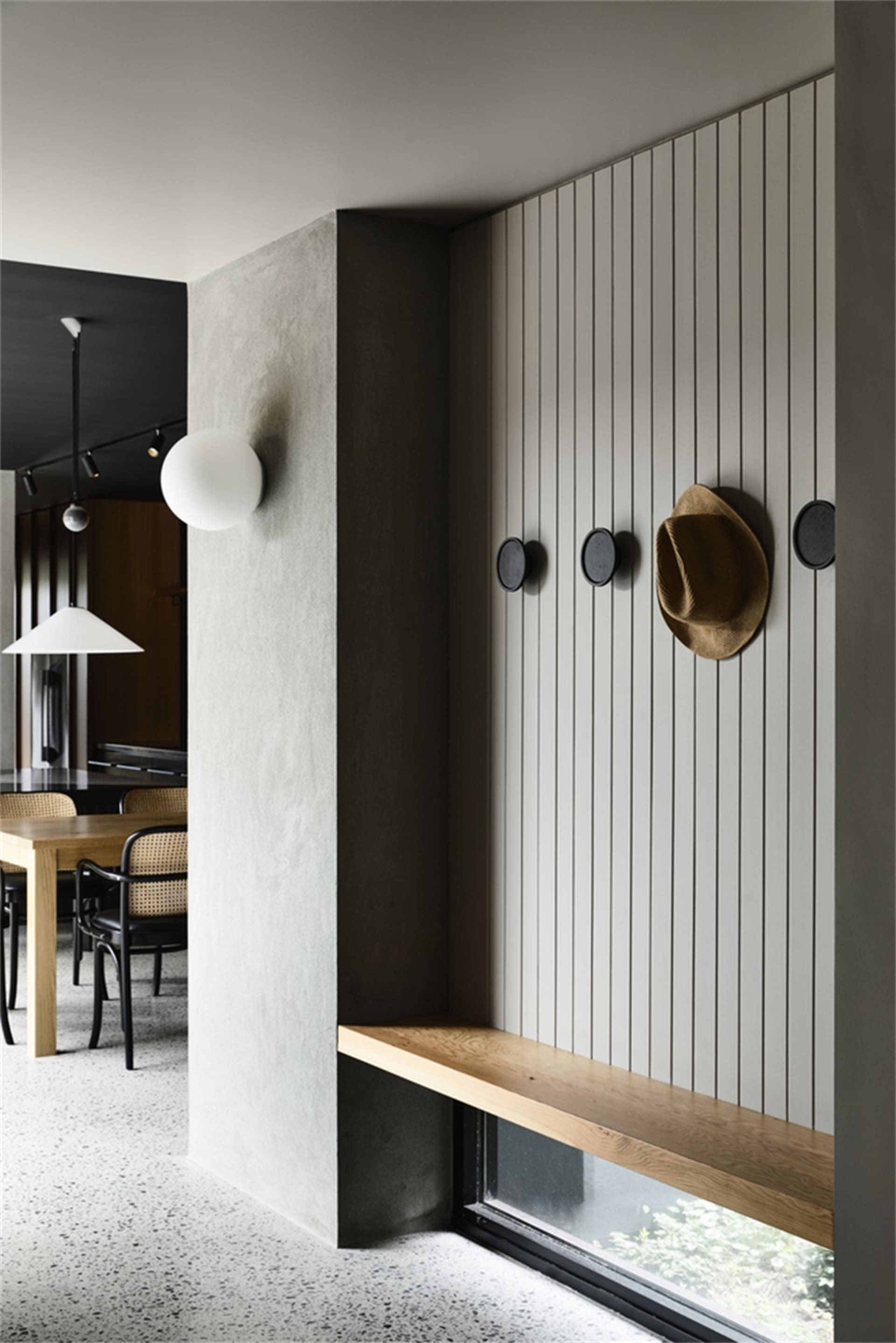 Industrial-style restaurant interior featuring concrete, wood, and metal elements.