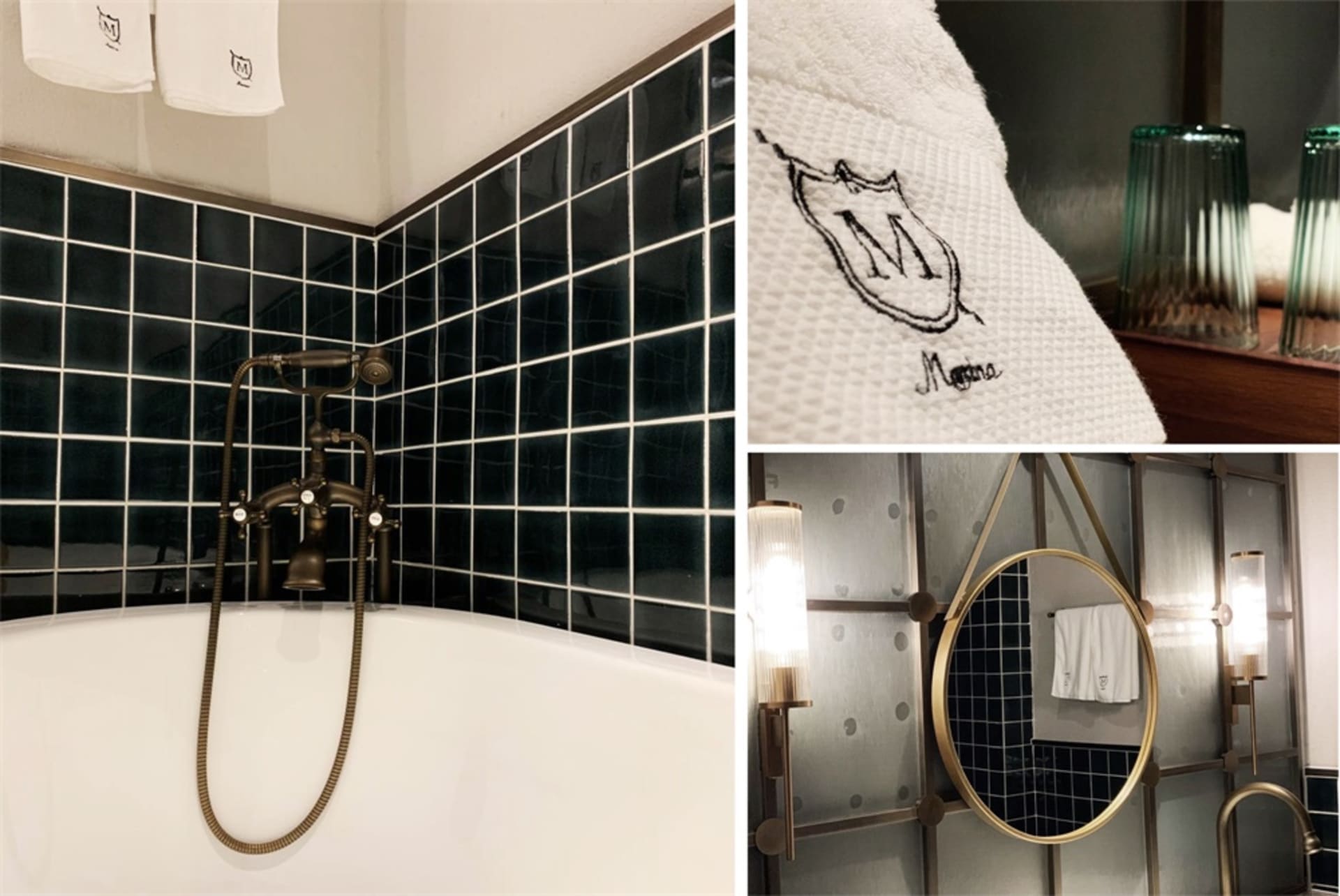 Modern bathroom with black ceramic tiles, a white bathtub, and a towel rack with a branded towel.