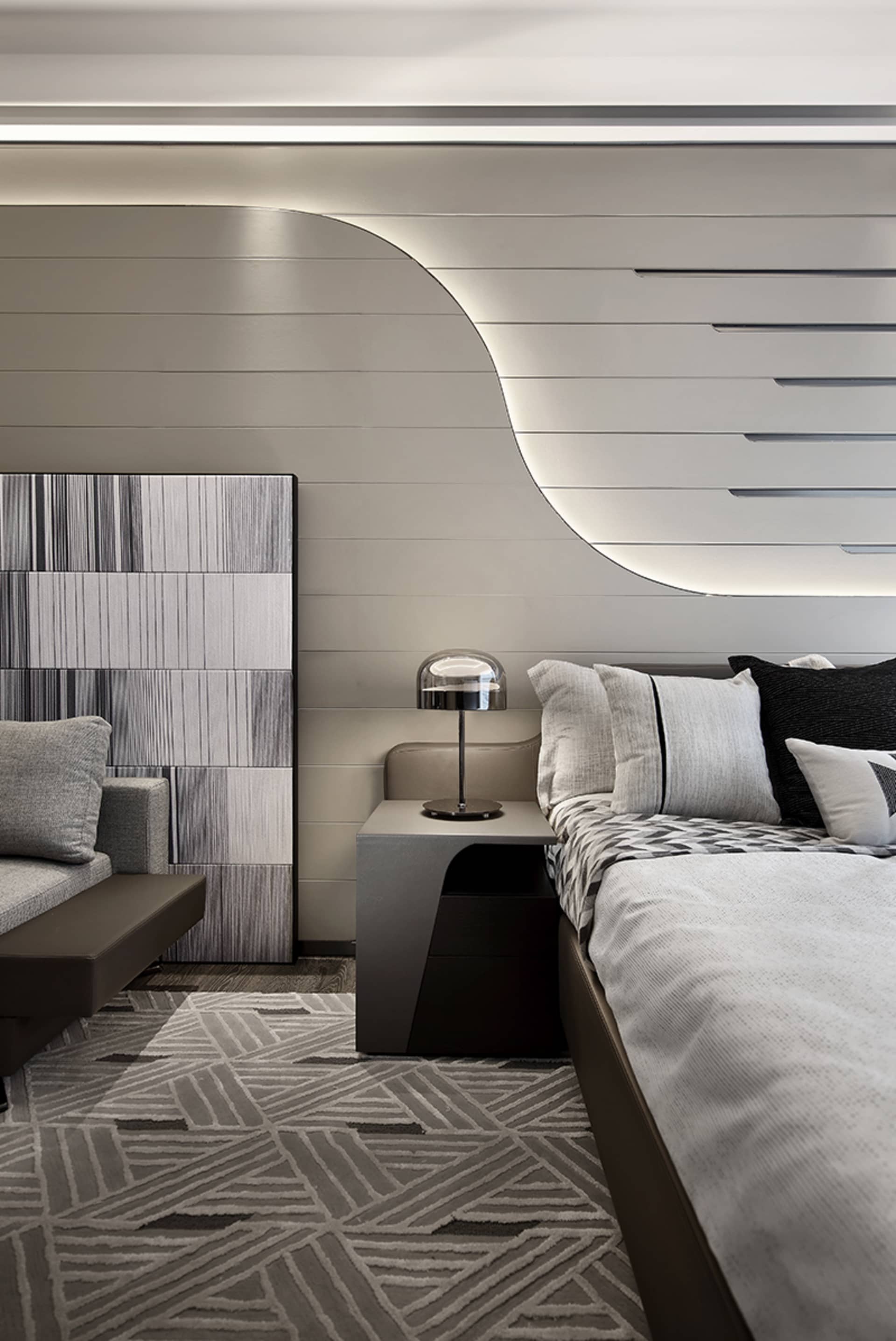 Modern bedroom featuring a textured wall design and minimalist decor.