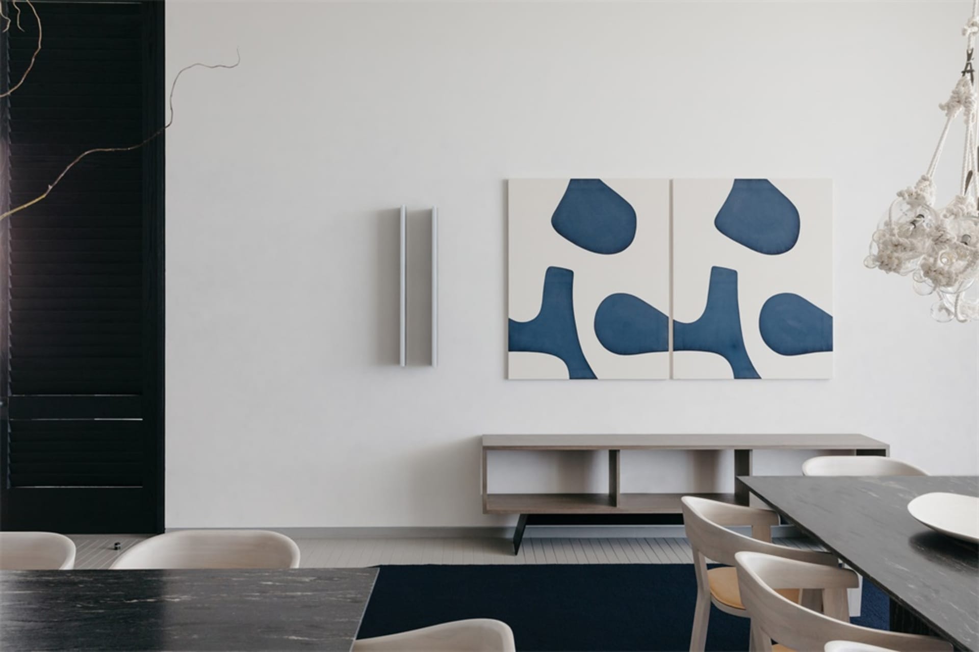 Modern living room with polished concrete floor, white walls, and abstract blue art on the wall.
