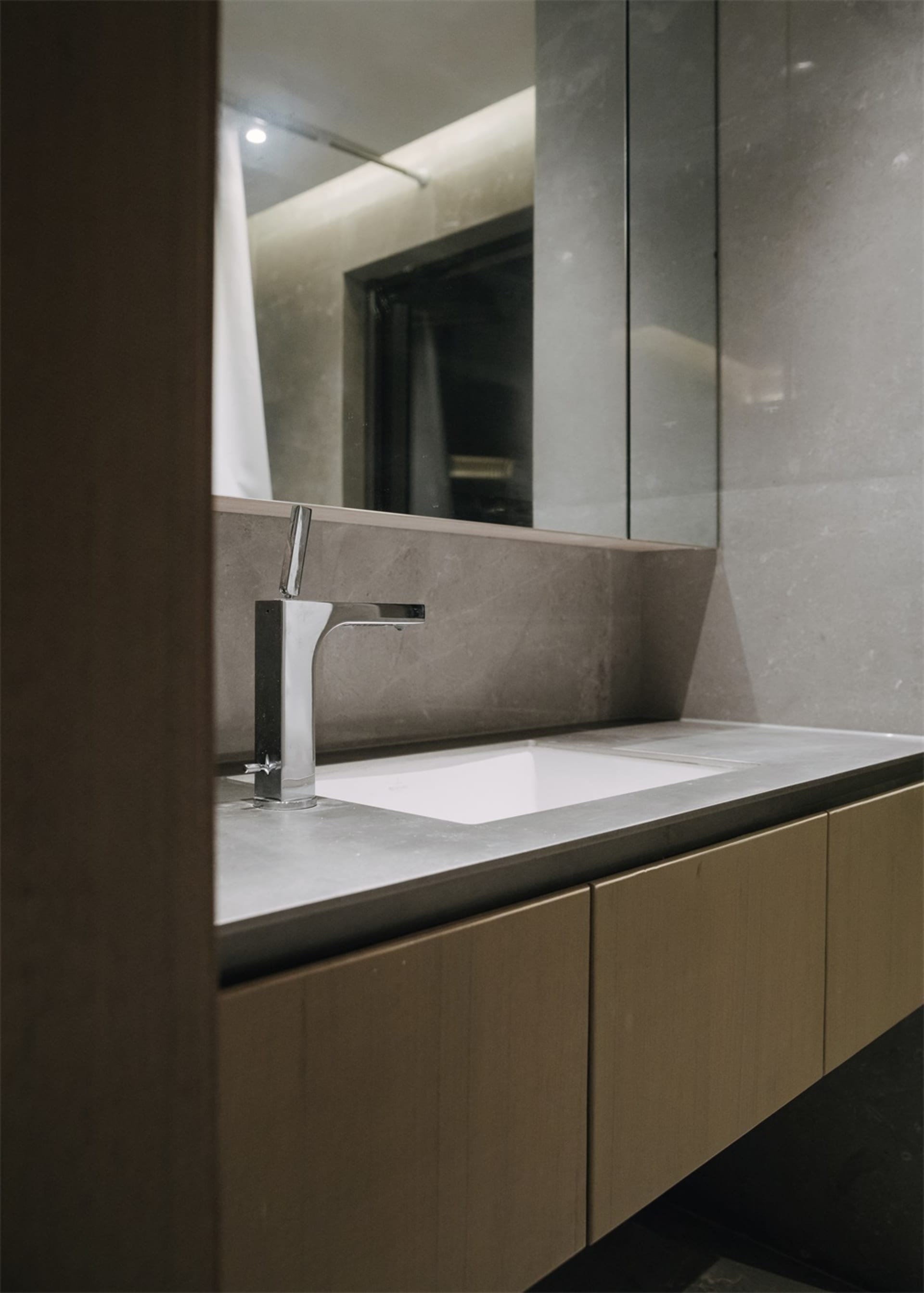 Modern minimalist bathroom featuring a concrete countertop and sink.