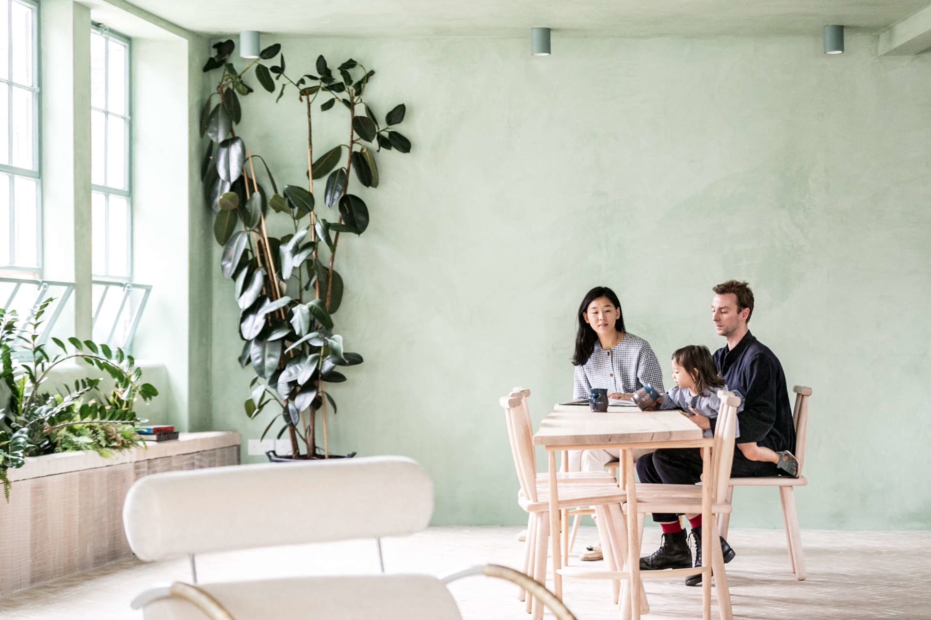 A cozy residential interior with wooden furniture and green plants.