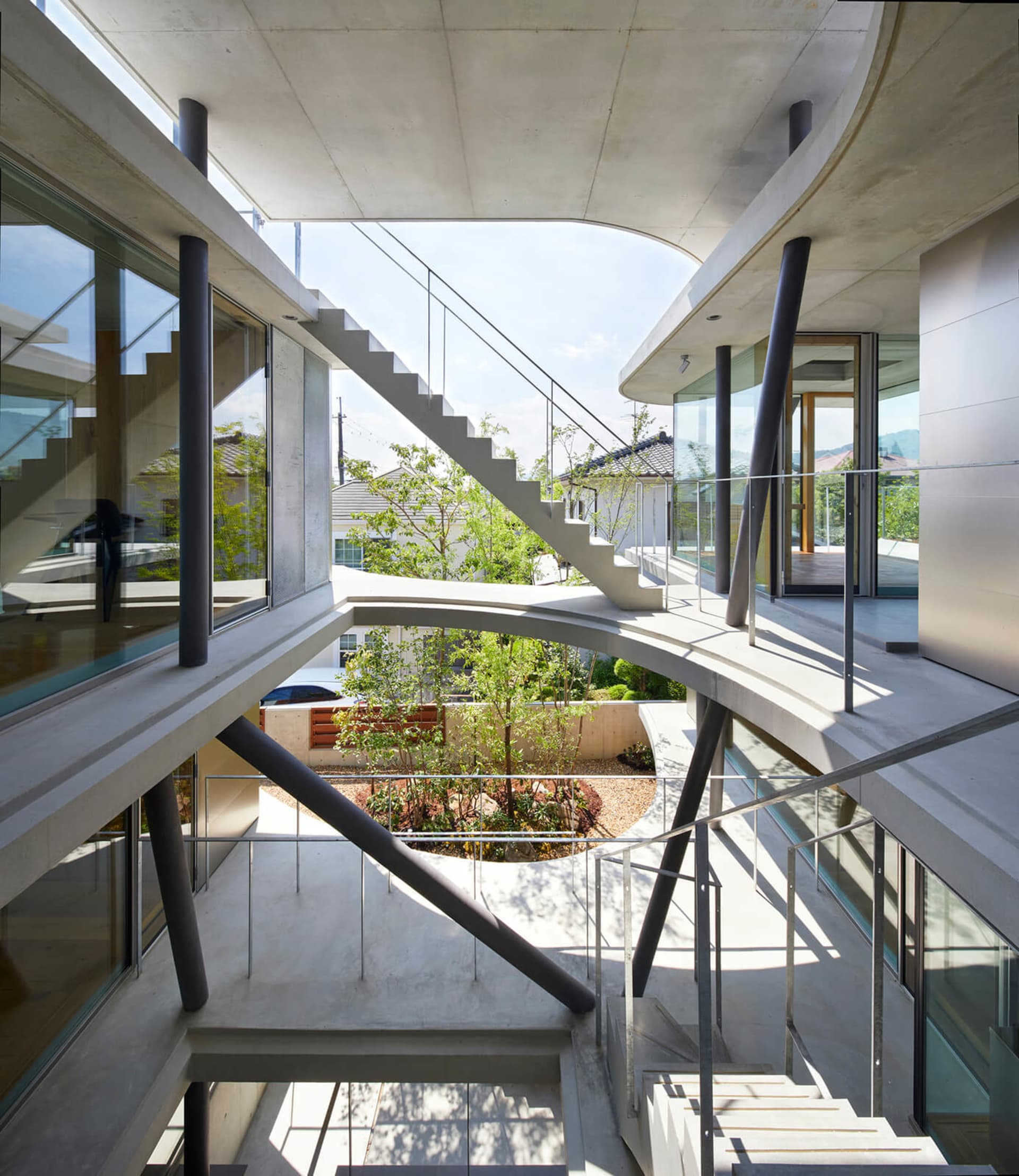 Concrete stairs with glass railings in a modern interior setting
