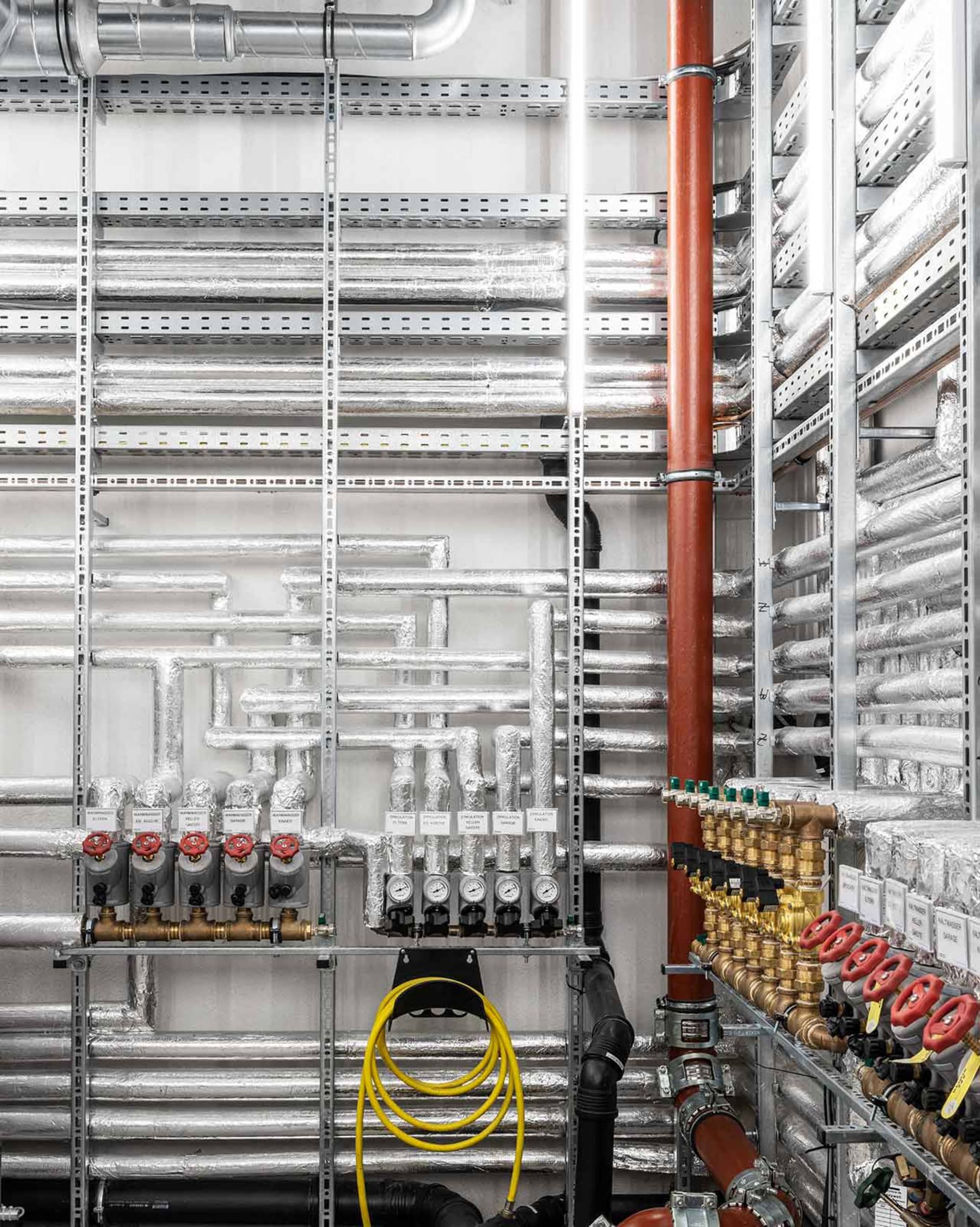 A detailed image of an industrial engineering space featuring metal structures and pipes.