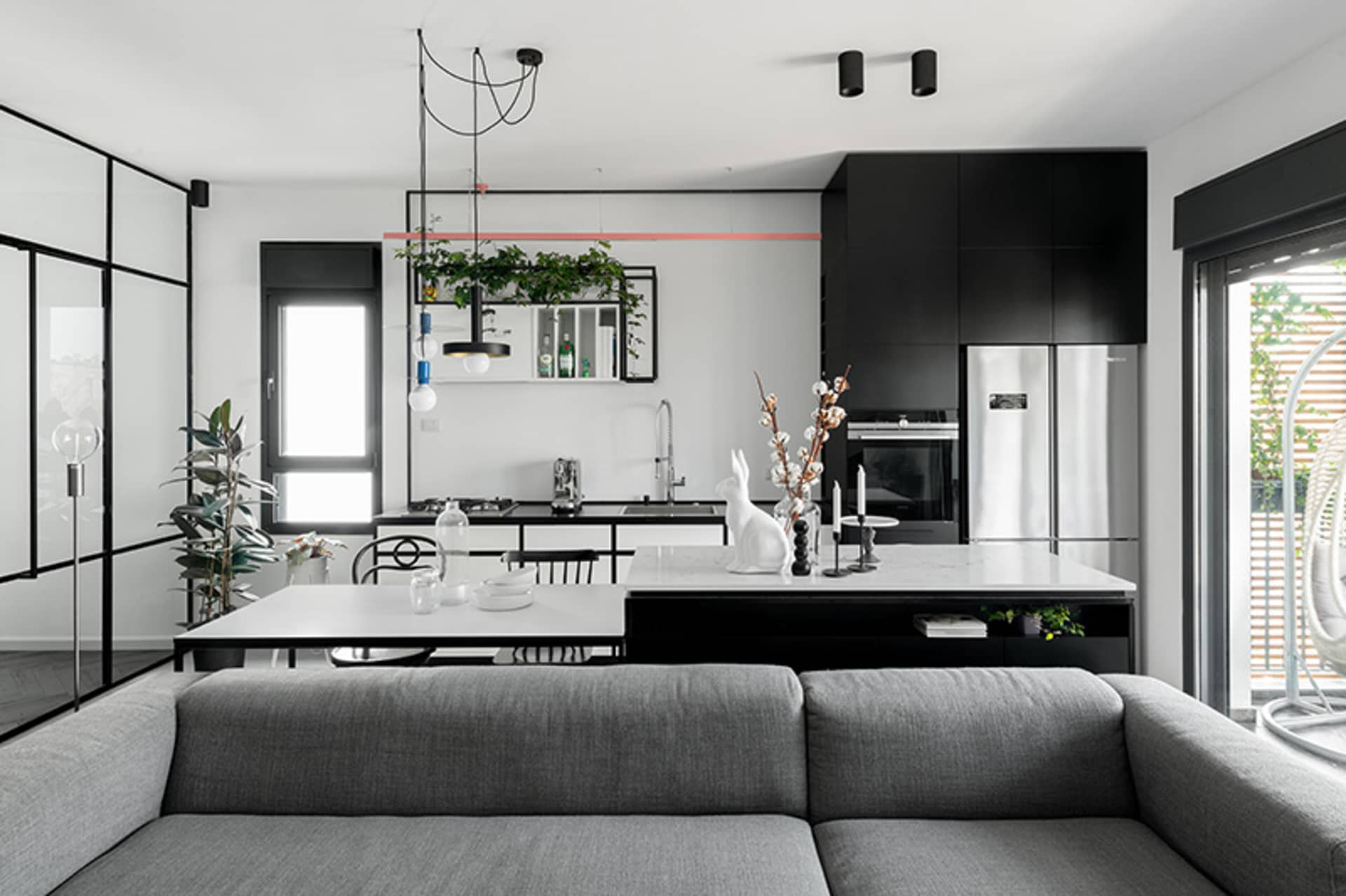 A modern residential kitchen featuring dark accents, clean lines, and a minimalist design.