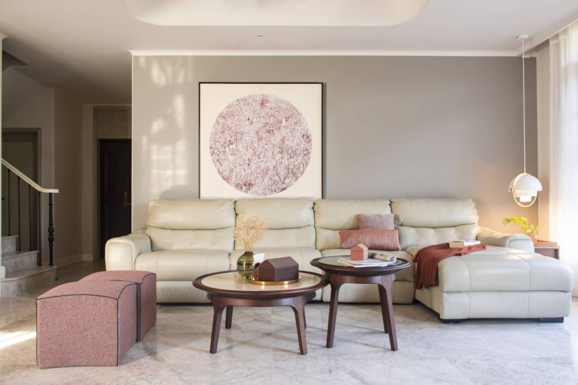 Modern living room with leather sofa and coffee tables.
