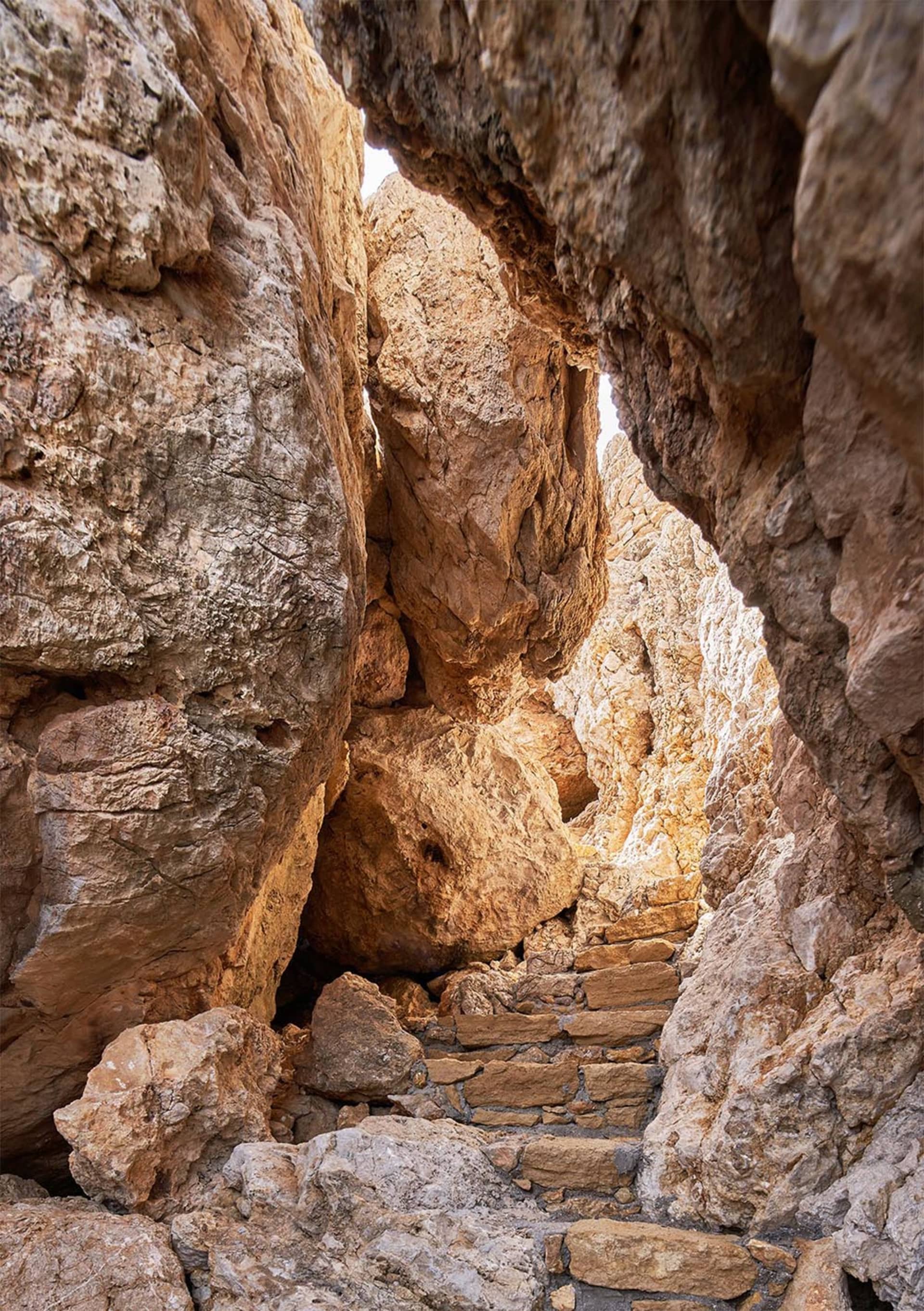 Rocky pathway through a cave entrance.