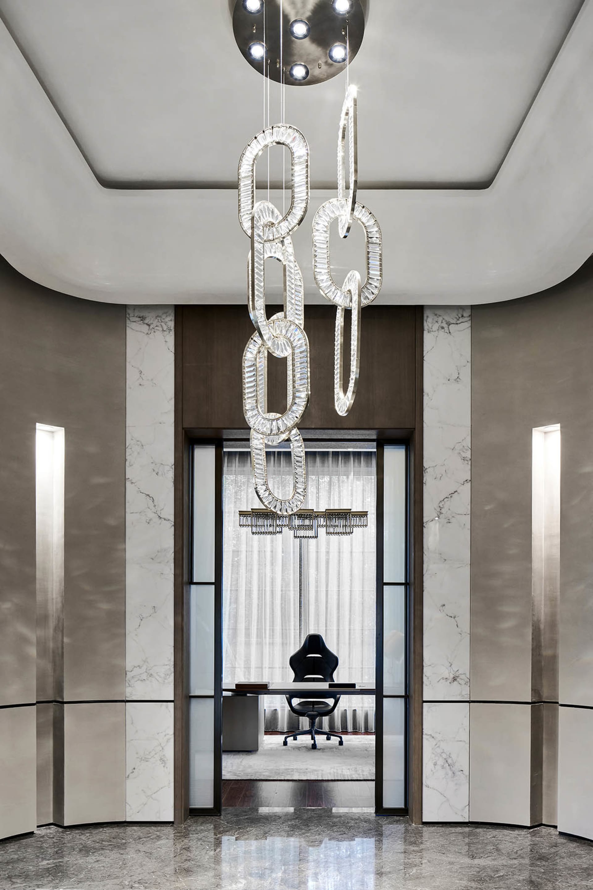 A modern executive office featuring marble finishes and elegant lighting fixtures.