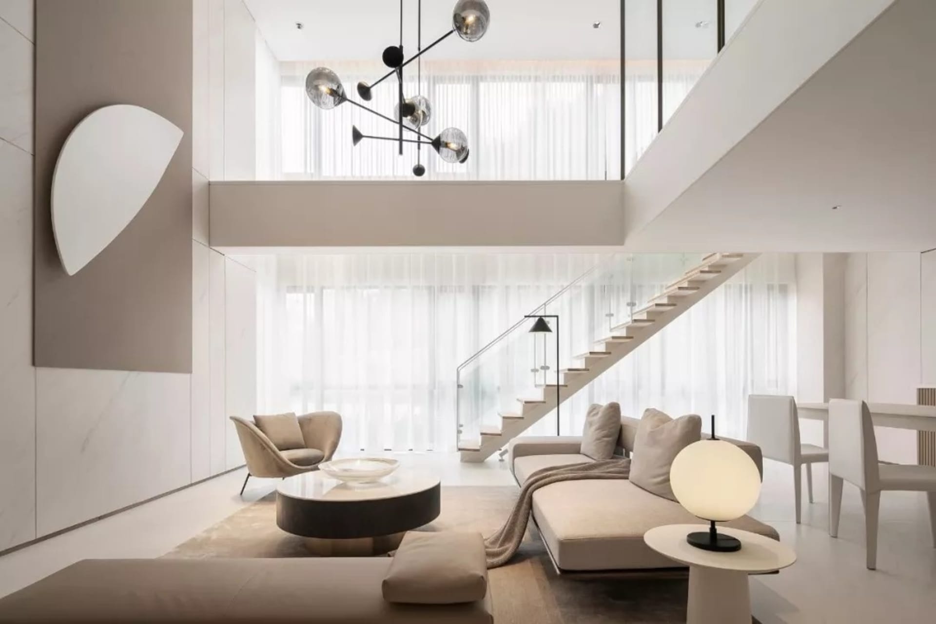 Modern minimalist living room with a neutral color palette, featuring contemporary furniture and minimal decorative elements.