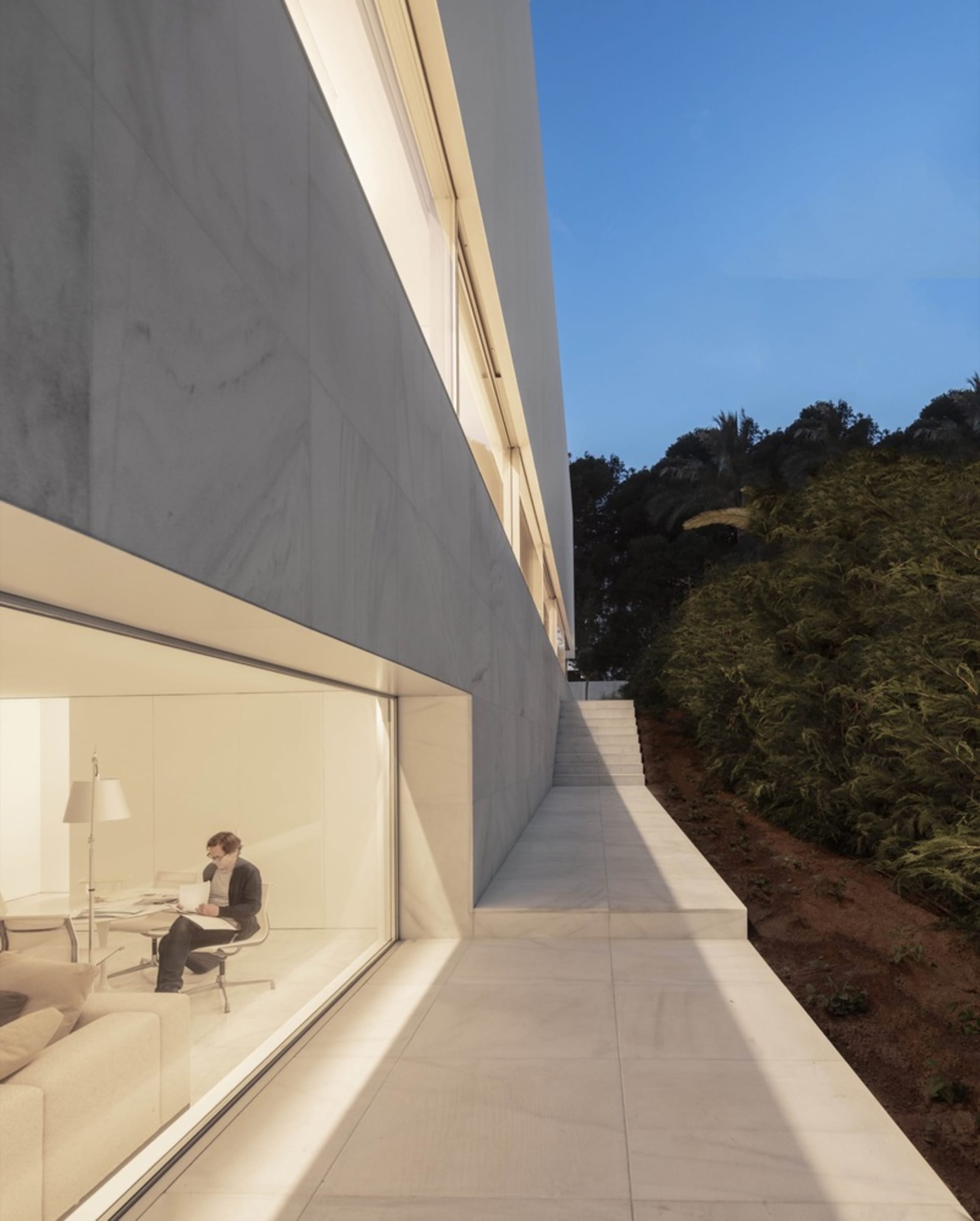 Modern residential building with concrete exterior and large windows