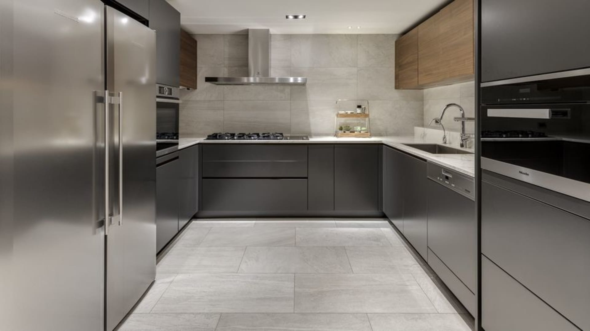 Modern kitchen with granite countertops and stainless steel appliances.