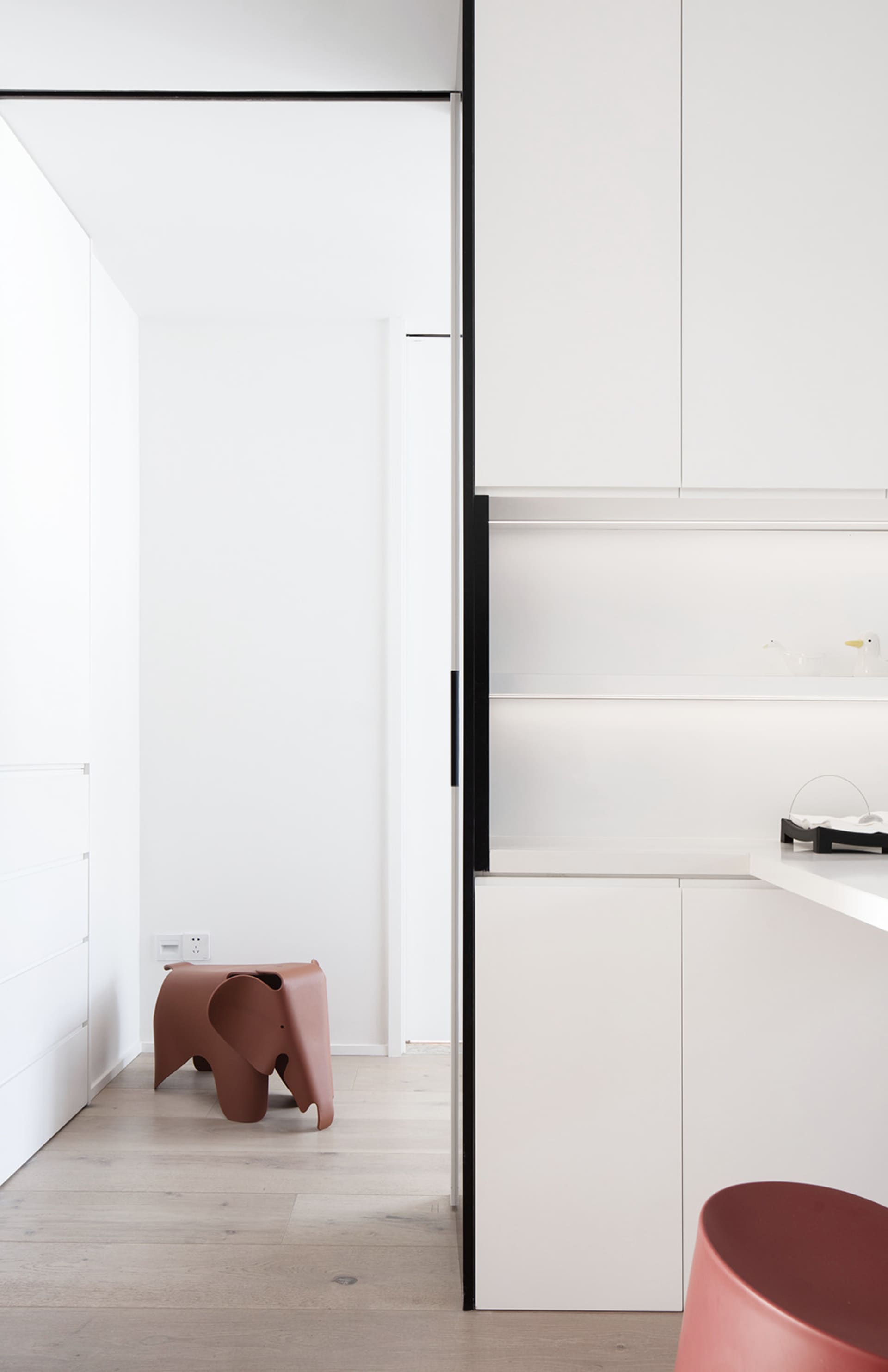 Modern minimalist residential kitchen with sleek white cabinets and clean lines.